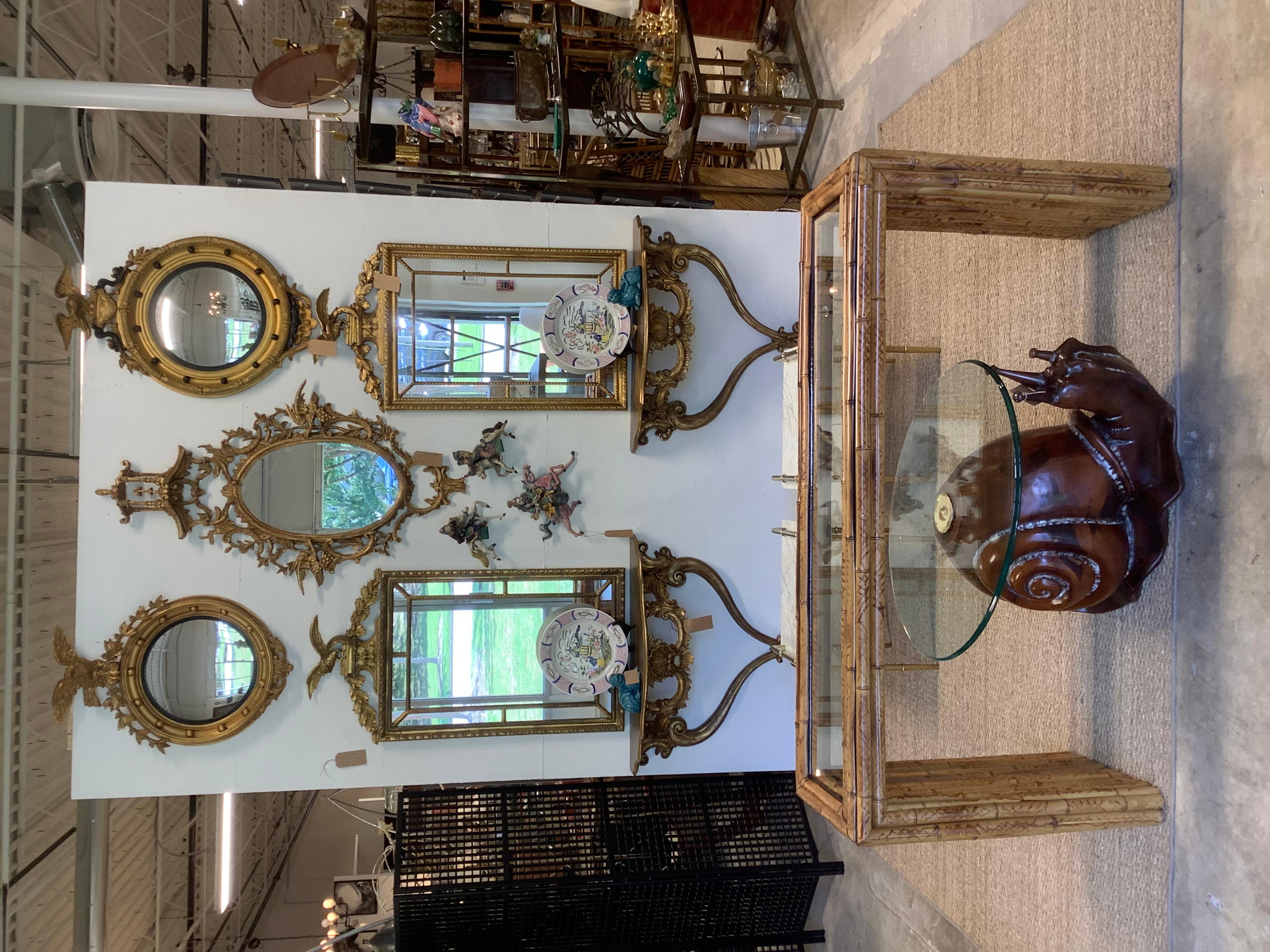 I love this snail table! I don’t see it very often, but have tried to buy one, several times. Very realistic, giant snail made of pine, and colored in a warm brown. Oval glass top with ogee edge. The glass attaches to the snail with a large brass,