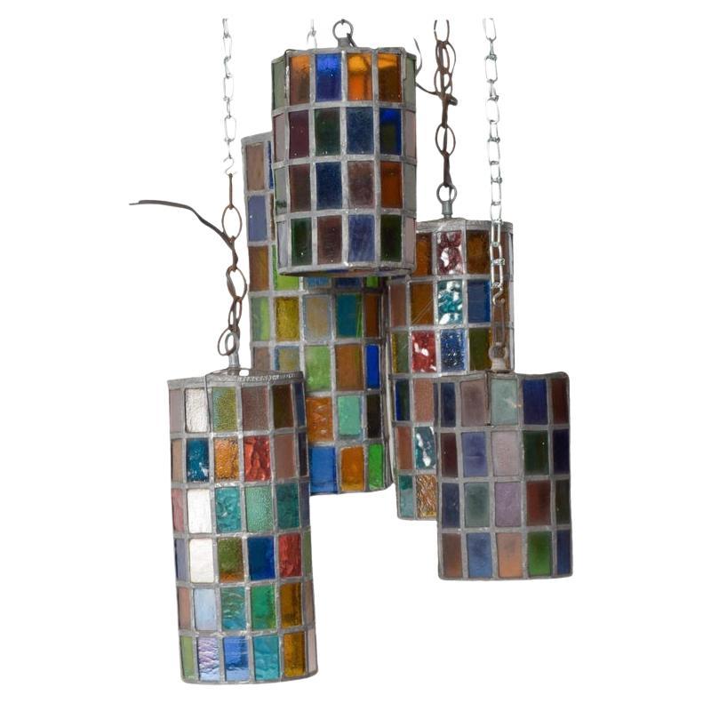 Five pendant lamps
Mexican Modernist Felipe Delfinger for Feders 1970s Mexico
Hanging pendant lamp set includes 5 lamps color stained glass
Measures: 3 sizes: 14.75 height (1), 12 height (2) 8 tall (2) x 5.5 in diameter
Original Vintage