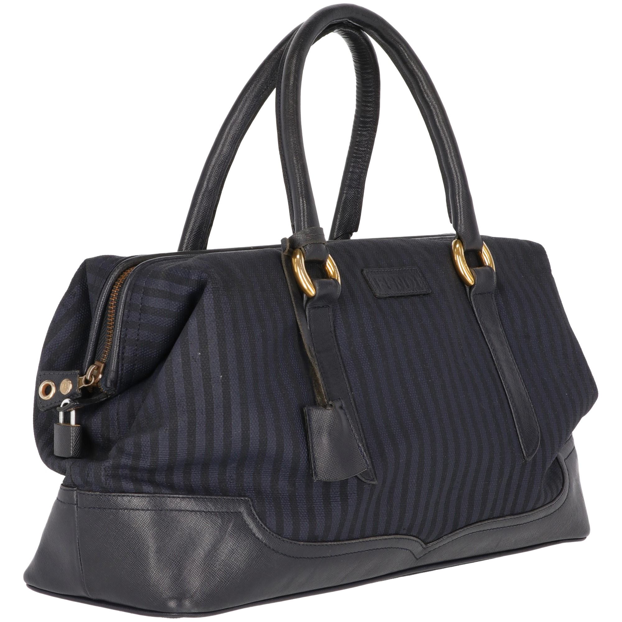 Fendi light and dark blue vertical stripes printed fabric handbag with blue leather handles and inserts, with zip fastening and gold-tone metal branded buckles. With blue leather real leather lining, inner zip pocket with gold-tone metal label. The