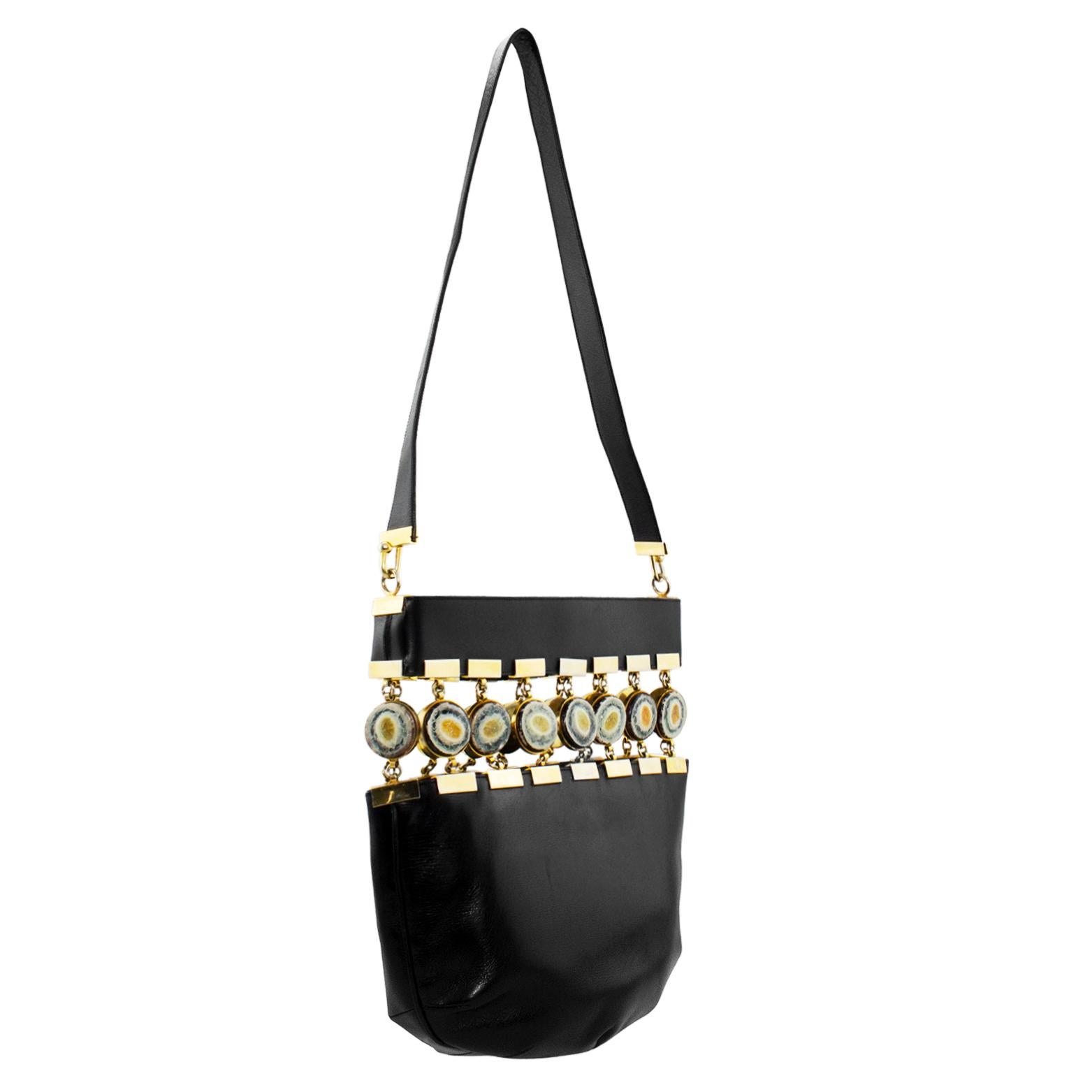 Very cool and unique Ferragamo black leather bucket style bag from the 1970s. The most intriguing  part of this bag is the cut out in the top half with round agate geodes set in gold tone metal and attached with gold tone metal links and