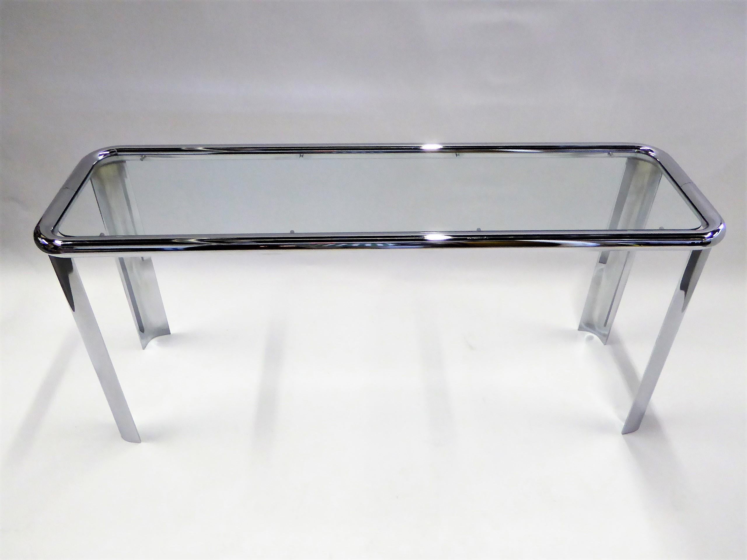 REDUCED FROM $2150....Spectacular 1970s tubular chrome race track console table with an inset glass top. Fat tubular top, the legs are quarter curve arc shaped. In very good condition with very slight oxidation on two legs (see pics). Very well