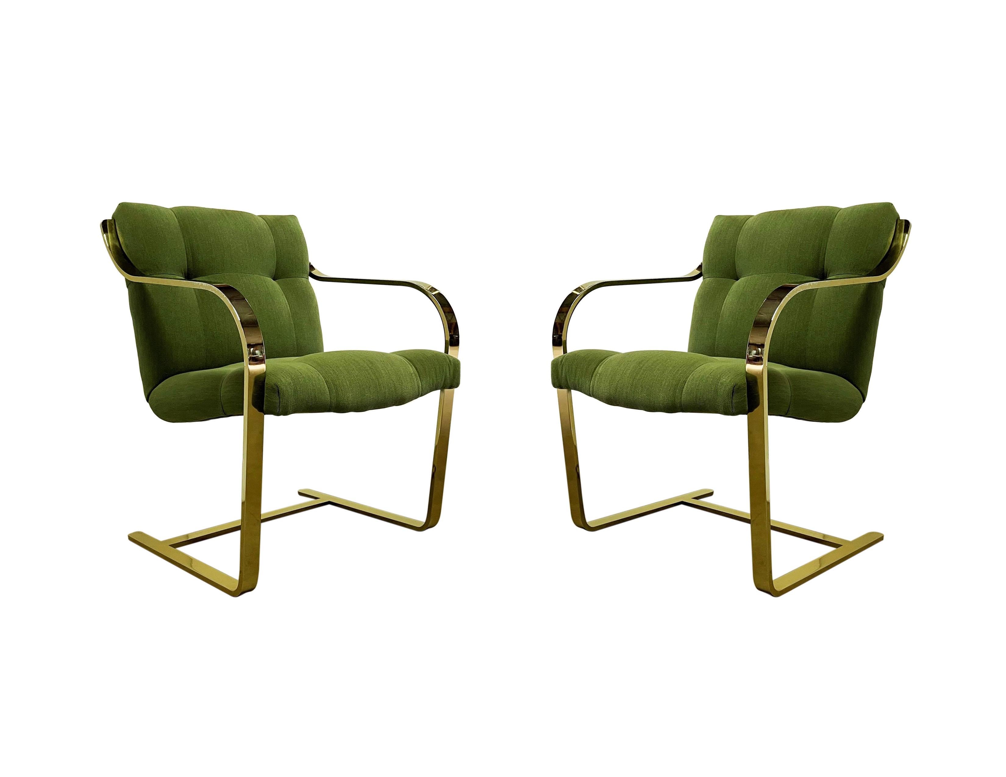 Inspired by the iconic Brno chairs, these hefty flat bar cantilevered chairs by Brueton. Distinguished by its flowing lines, featuring stainless steel frames in a rare brass plated finish. Welded, ground and polished into a seamless unit that