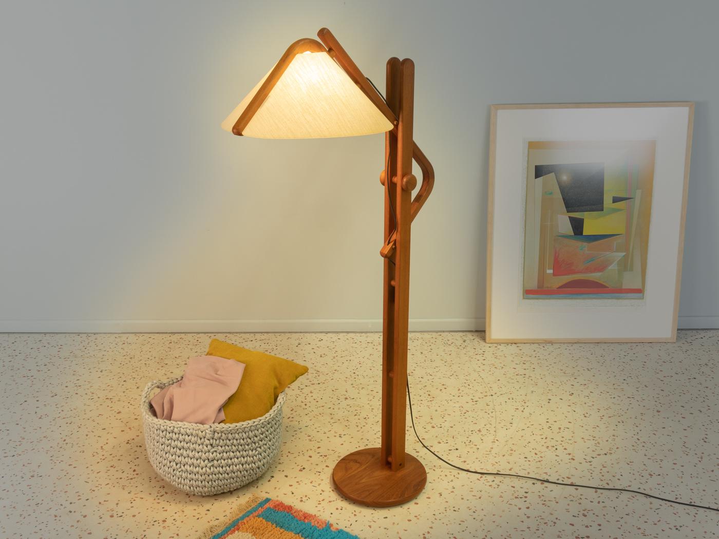 Exclusive floor lamp from the 1970s. Frame and base made of teak with a cream white lampshade.
Height 132-153 cm 

Quality Features:
 very good workmanship
 high-quality materials
 Made in Germany, manufacturer: Domus.