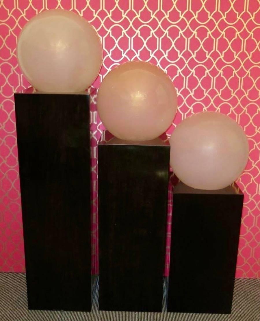 Murano floor lamps from the 1970s. Formed by a series of three large glass spheres positioned on three different wood parallelepipeds. These are of three different heights, cm (92, 112, 132); Inches (36.25, 44.13, 52). The three parallelepipeds are