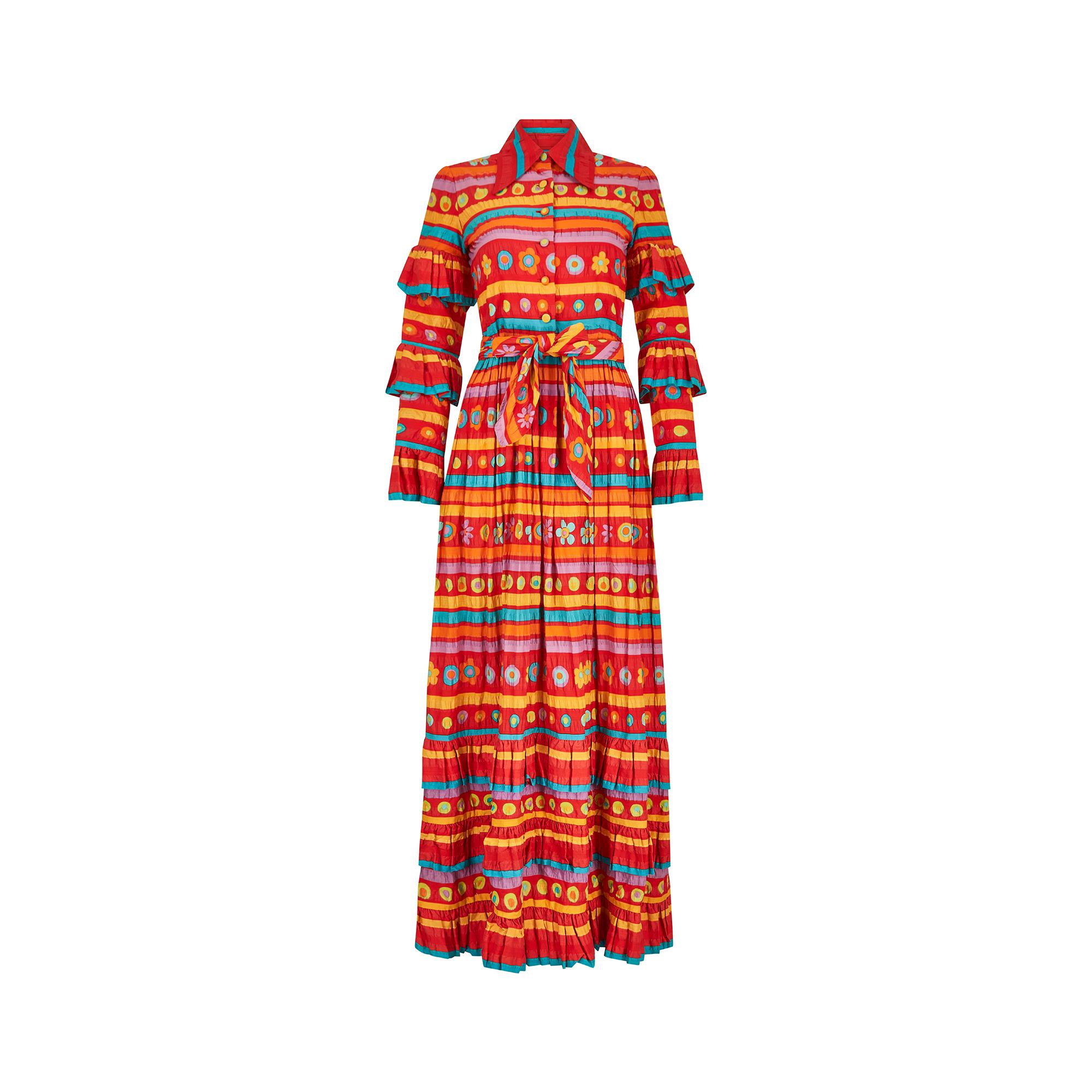 This is a really fun 1970s maxi print that reminds me of a fiesta dress.  It has brightly coloured coordinating stripes interspersed with a roundel and floral arrangement in red, turquoise, orange, purple, yellow and green.  The unusual material is