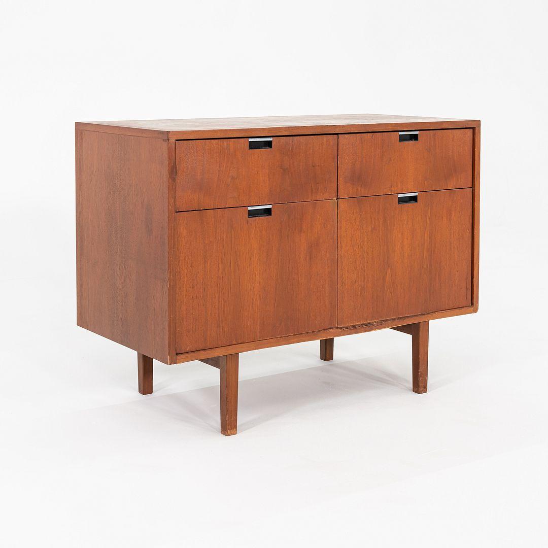 This is a 1970s Florence Knoll Two-Position Credenza, originally designed by Florence Knoll in 1958. It has a case composed of walnut. There are two top drawers and two larger drawers on the bottom that are ideal for files. The piece also features a