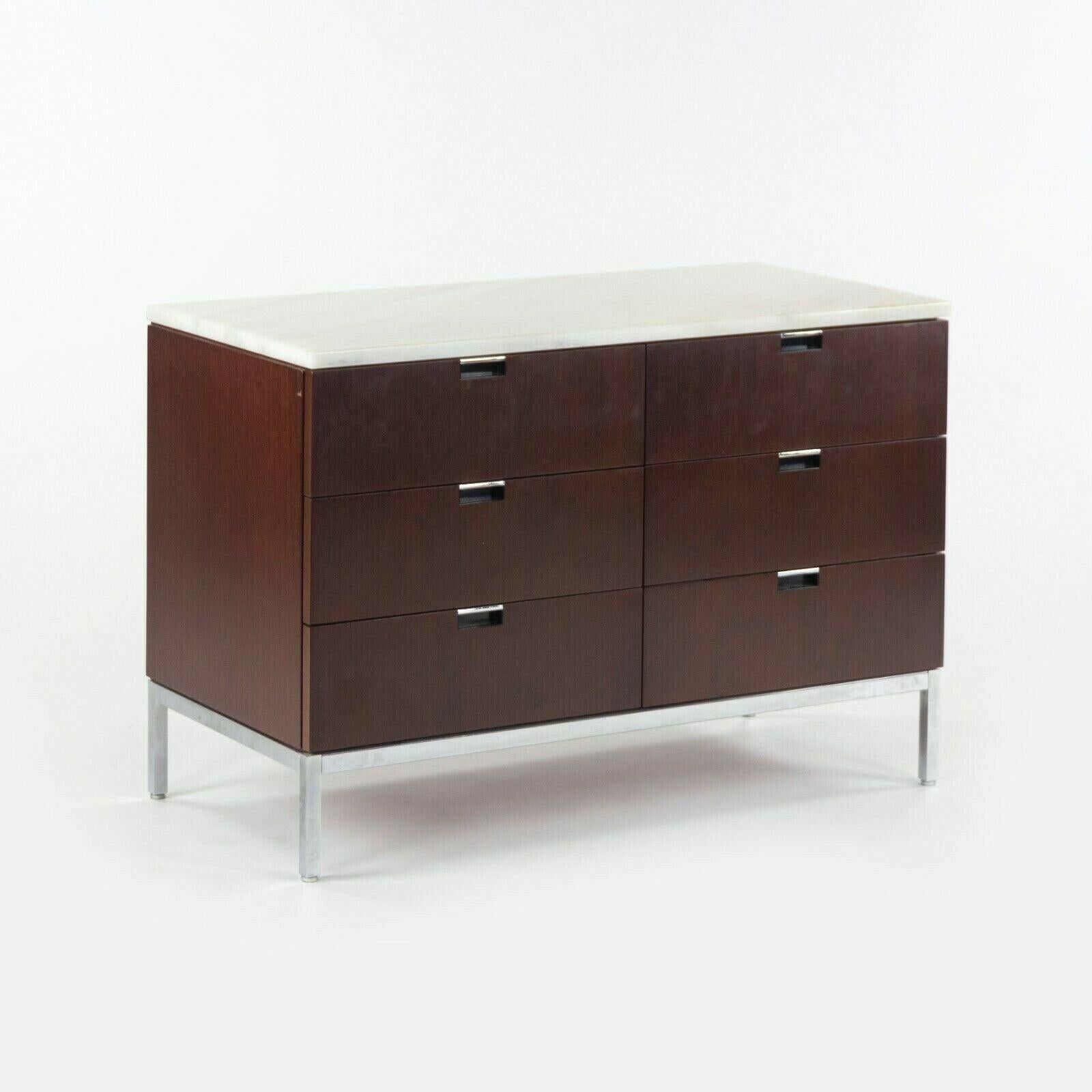 Listed for sale is a gorgeous original 1970s Florence Knoll 6-drawer credenza/dresser, produced by Knoll International. This example has a dark mahogany finish with original marble top. The finish is original and in very nice condition. The marks on
