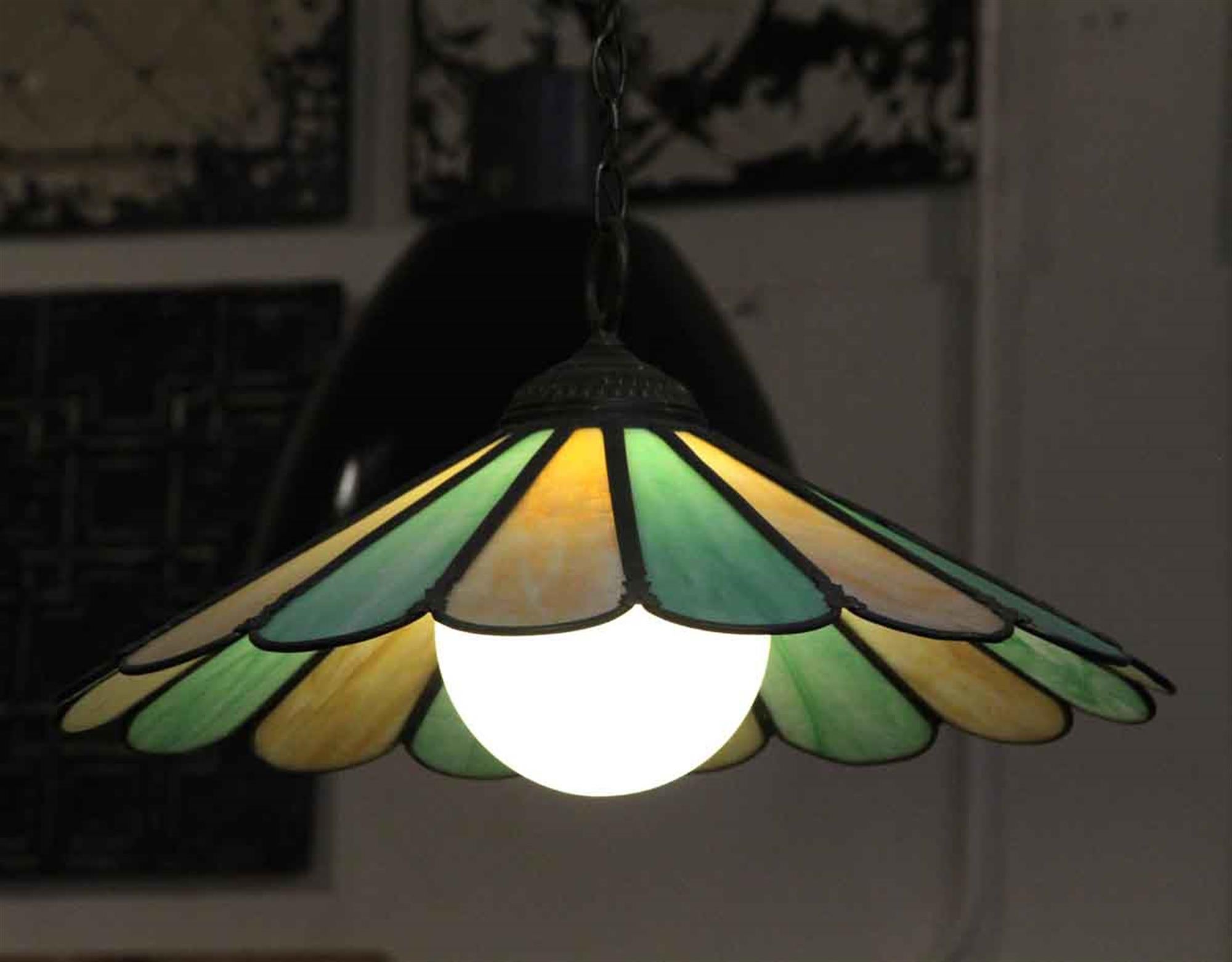 This hanging green and yellow stained glass petal shade is straight from the 1970s psychedelic era! It includes a chain and canopy and is newly wired and ready to go. This can be seen at our 5 East 16th St location on Union Square in Manhattan.