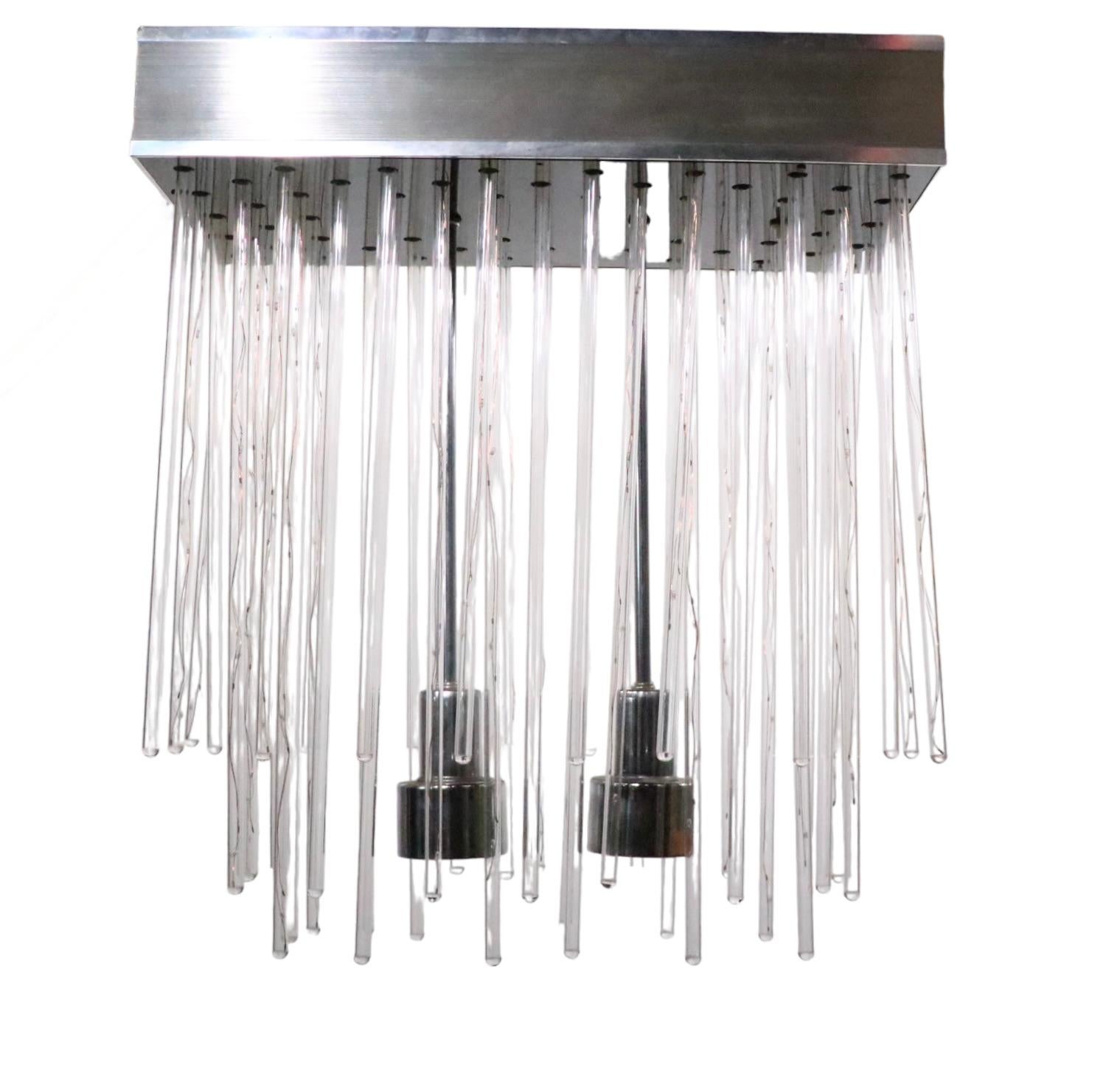 Incredible 1970’s fixture having ( 53 ) lucite rods that  are suspended from the rectangular metal box, which mounts directly to the ceiling. Some lucite tubes contain a filliment, making them illuminate, some do not have the filliment, this is by