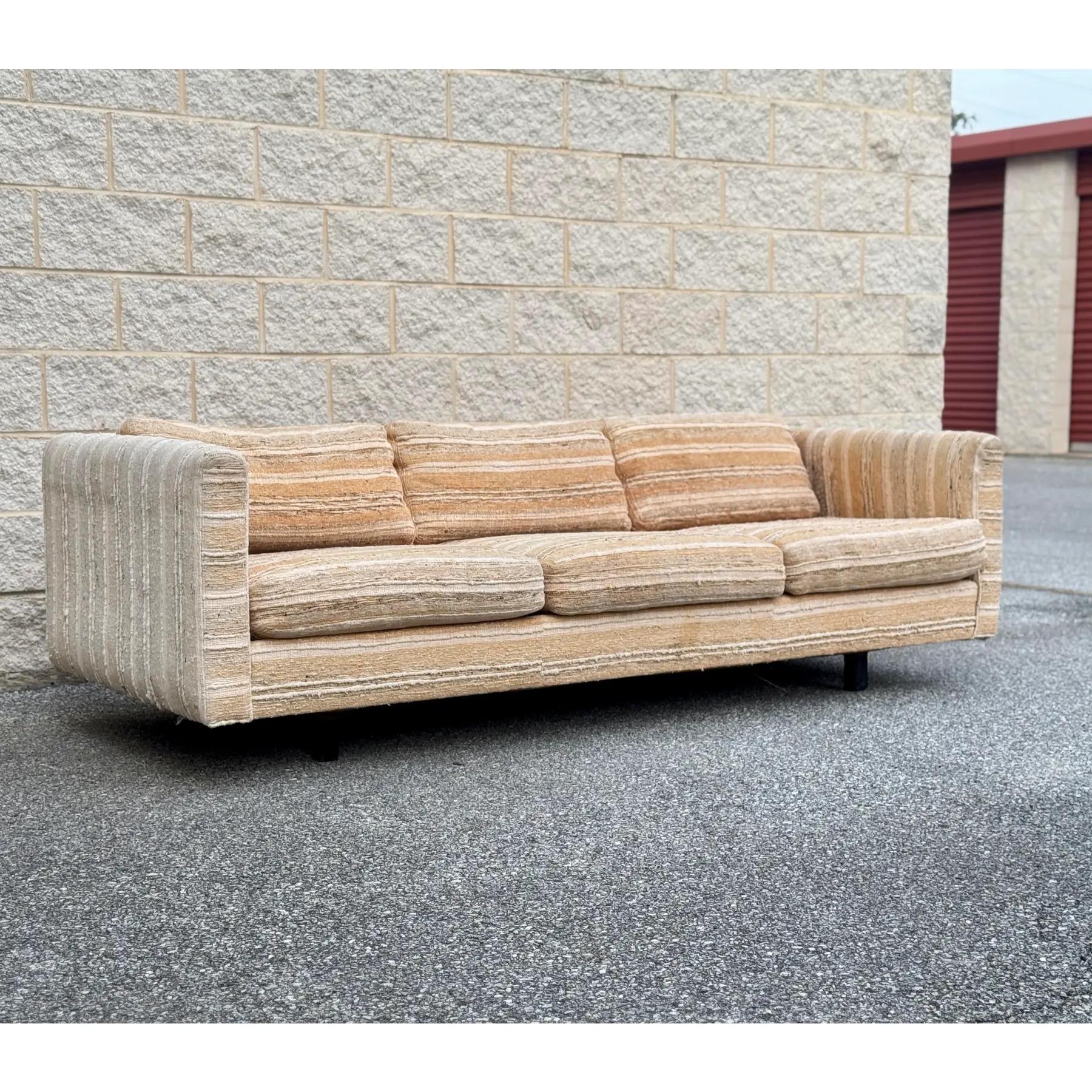 A rare 1970s Forecast Furniture sofa features a luxurious, thick, textured upholstery in earthy neutrals.

The sofa’s low-profile frame and sculptural design are influenced by the timeless style of Milo Baughman and the classic tuxedo sofa. Features