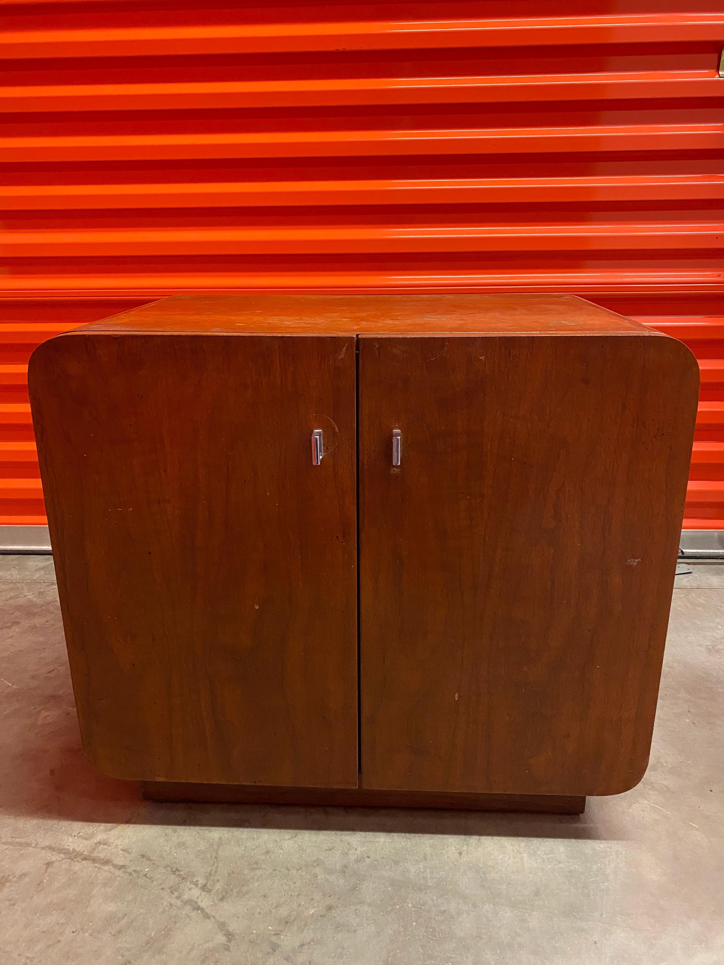 A pair of Mid-Century Modern nightstands by Thomasville Furniture, Founders Collection. Rounded corners give this set a unique shape. Two doors open to interior cabinet with shelf. Square chrome pulls. Loose pull in photo has been
