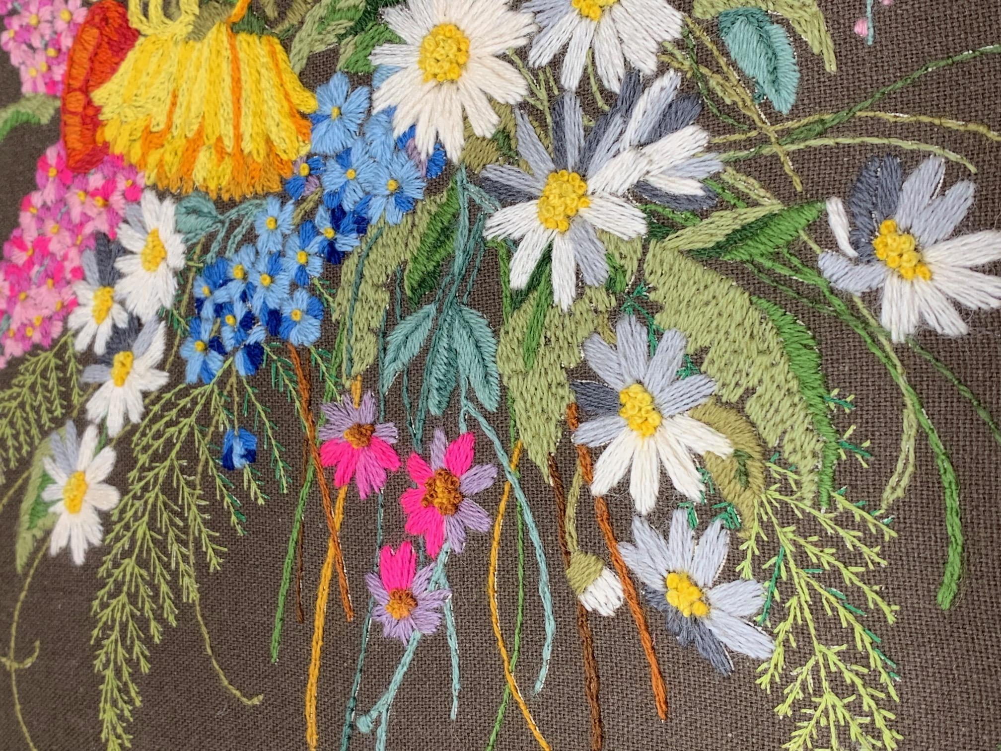 Framed wall embroidery features beautiful floral motif on dark khaki fabric with wood frame, circa 1970s. Very good condition.