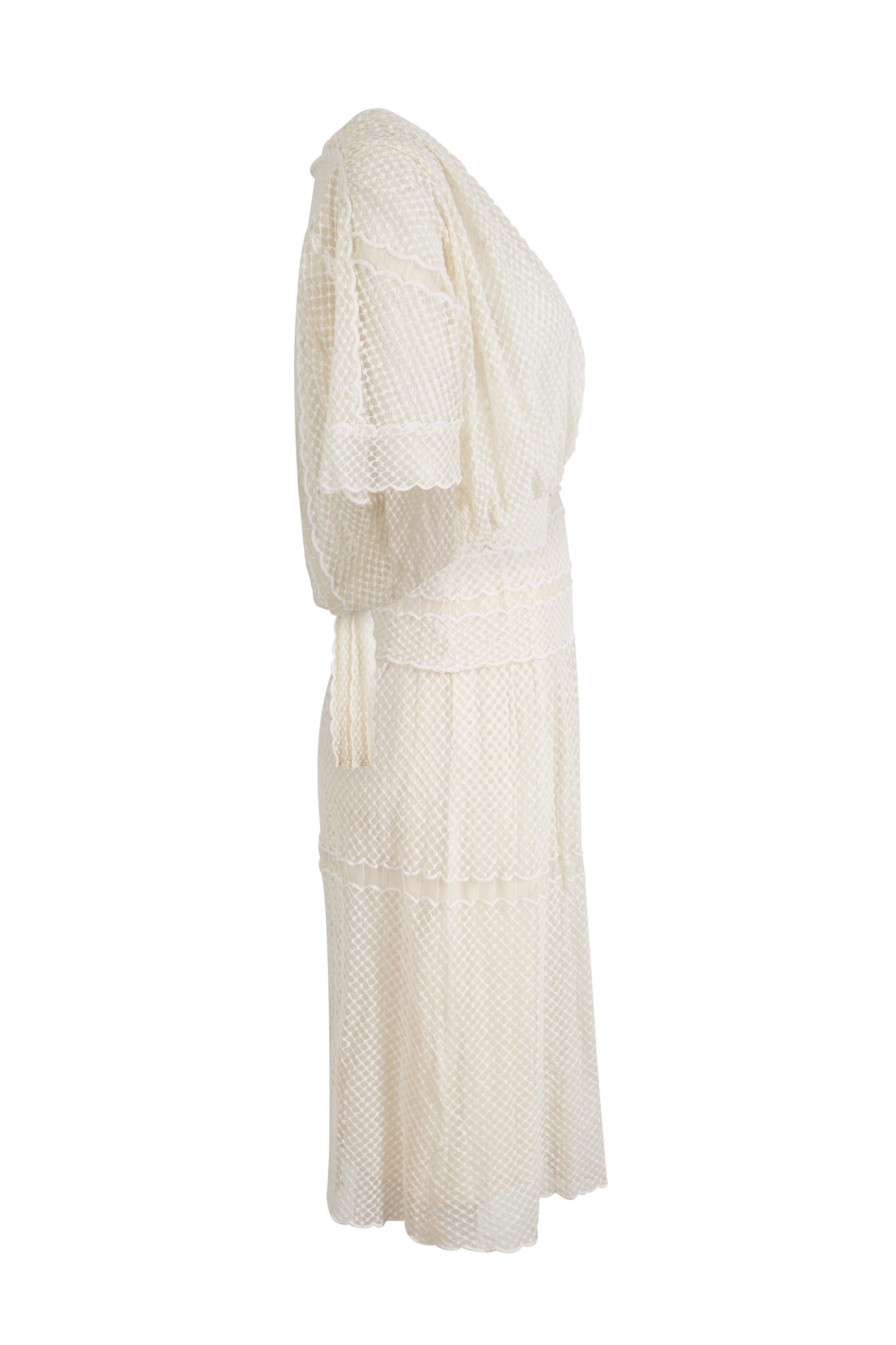 This charming 1970s ivory lace dress with matching bolero is by popular British designer Frank Usher and is in wonderful vintage condition with some exquisite design features. The dress has a beautiful simplicity of line and emulates a 1950s style