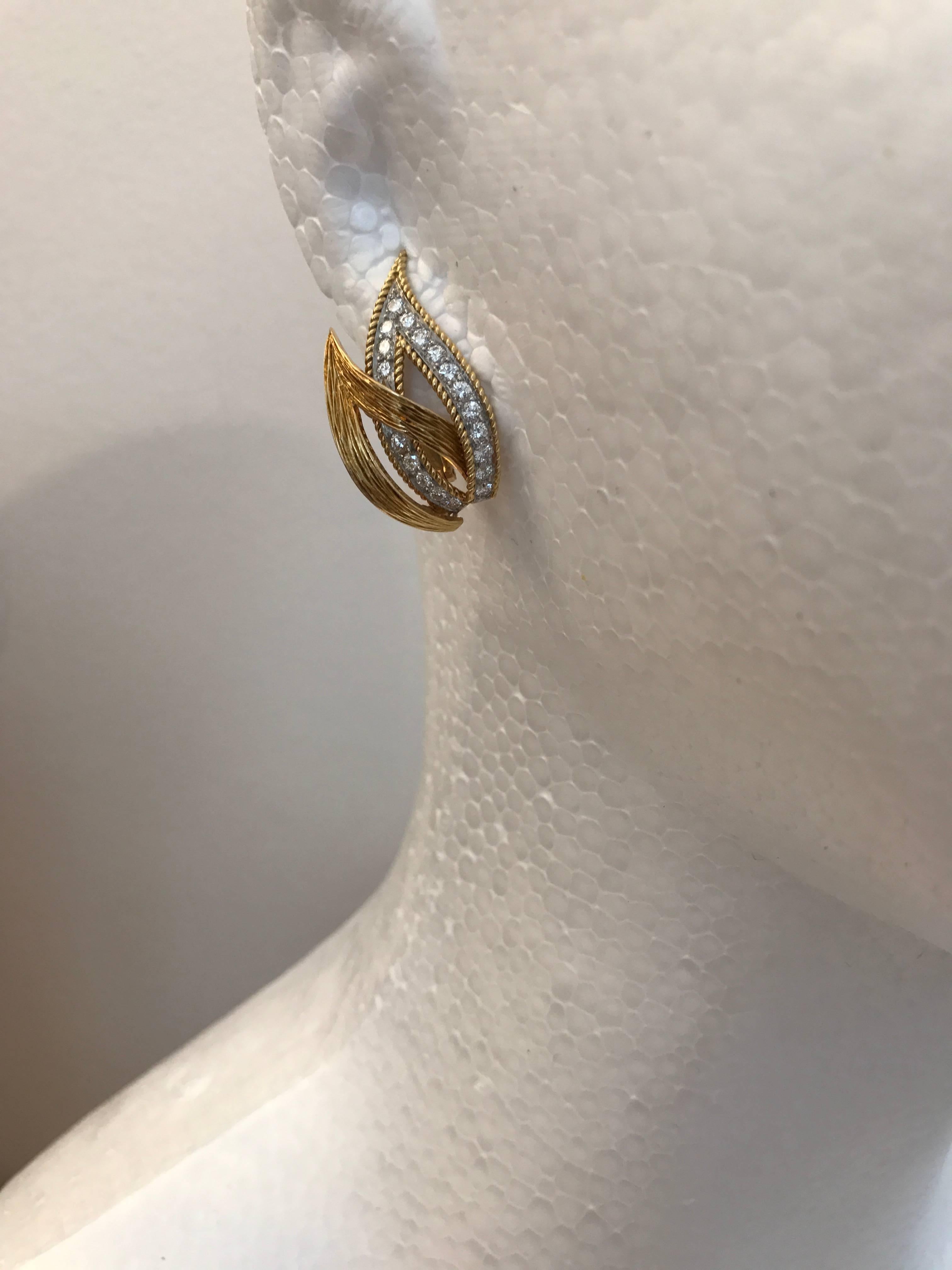 A charming pair of 18ct yellow gold and diamond double open leaf earrings of superb quality made in France, circa 1970

Length of earrings 3cms