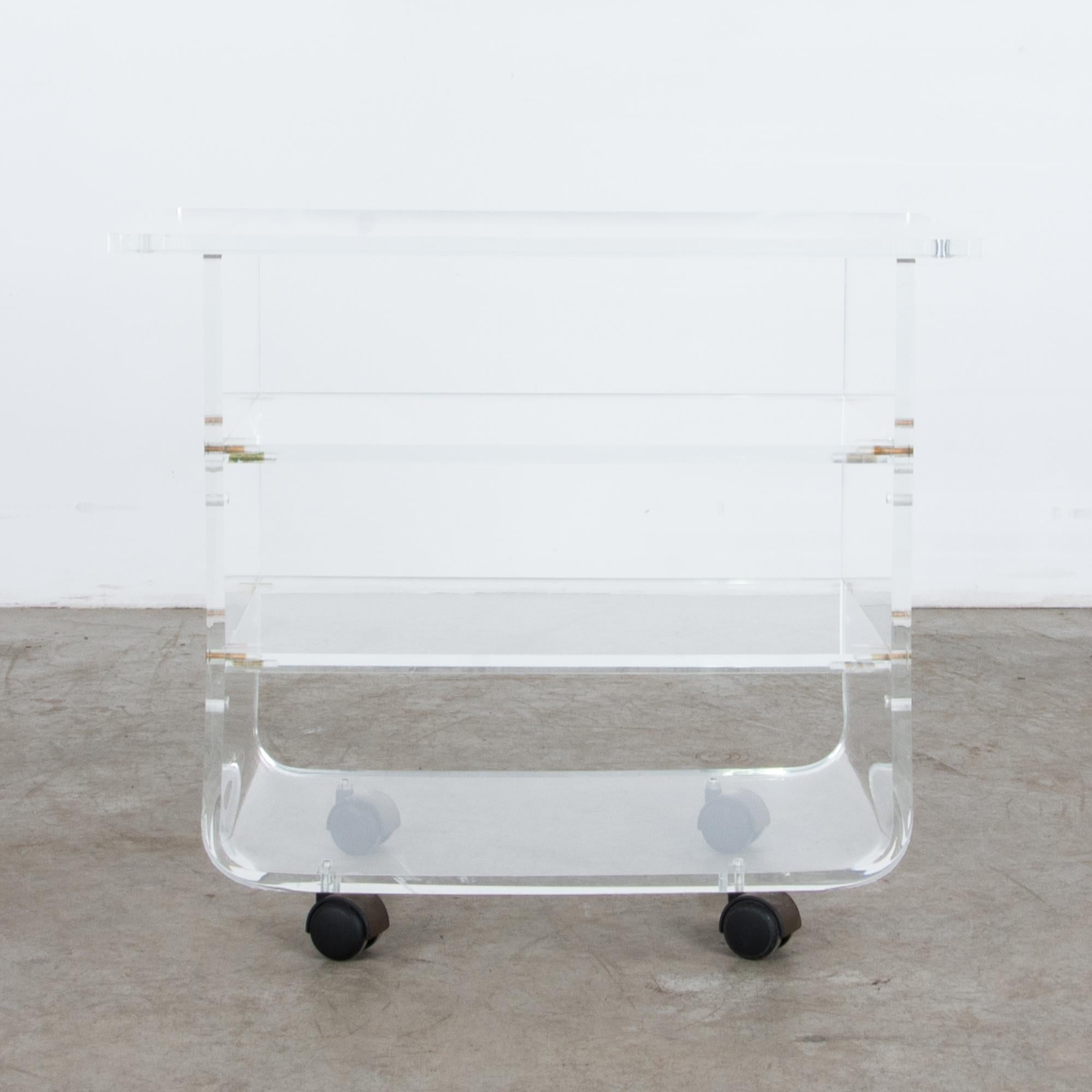 Smooth to transparent, on wheels. This 1970s French cart revels in the ideals of high Modernism, speed and sleekness, rounded edges and striking geometries revered in high tech materials, with a subtle accent of brass— a reminder of luxury. A vision