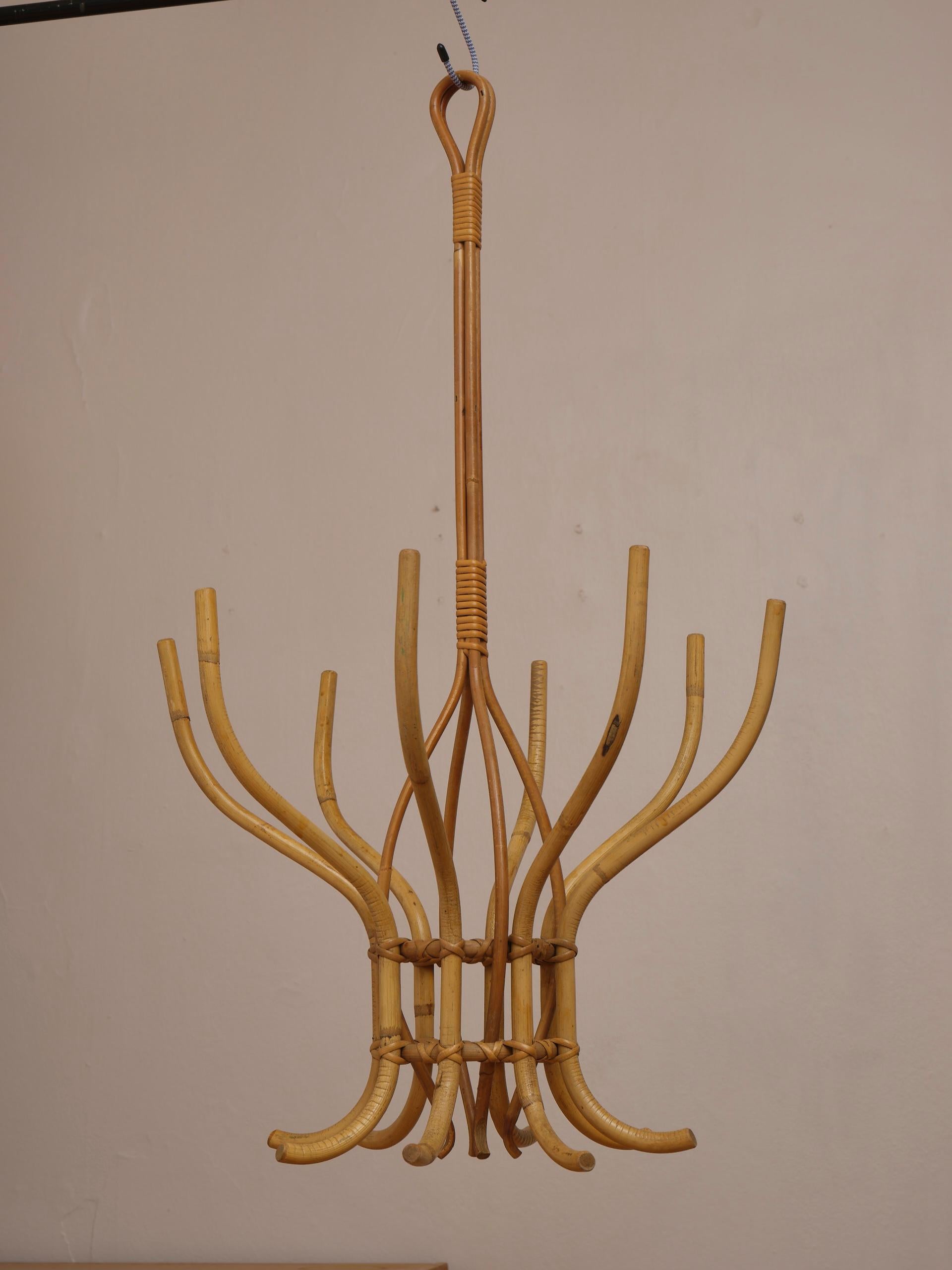 Hanging from the ceiling, this French vintage bamboo / rattan hanger is great for night gowns and bathrobes in the bedroom, towels in your bathroom or jackets in your hall. Or anything in any room. It has 8 hangers, that can be used both on top and
