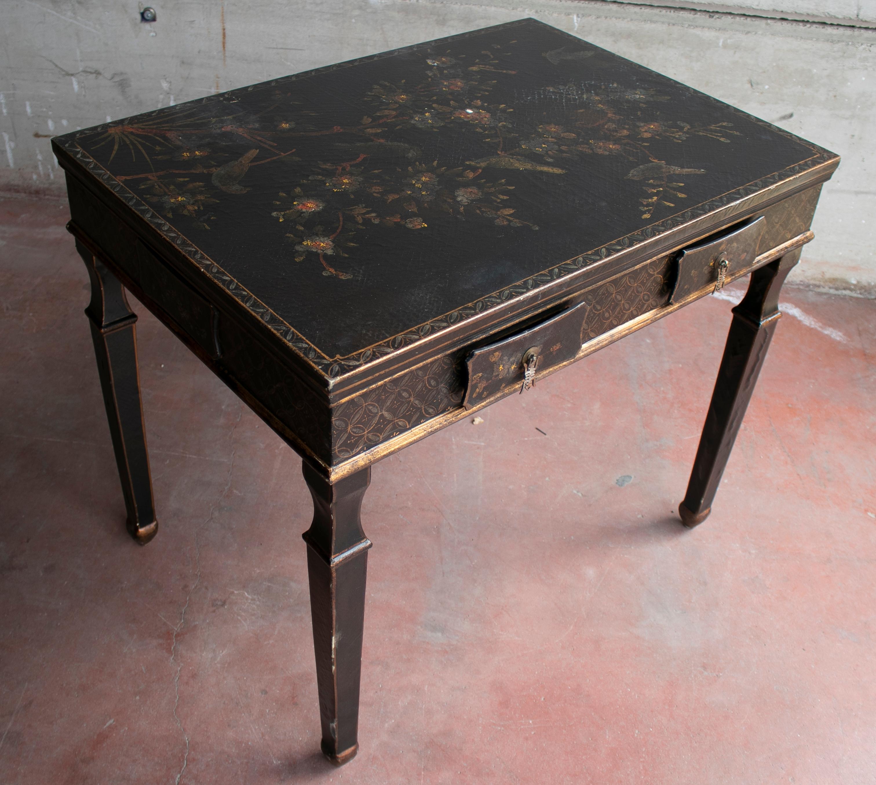 1970s French black lacquered one drawer table with hand painted bird and flower decorations.