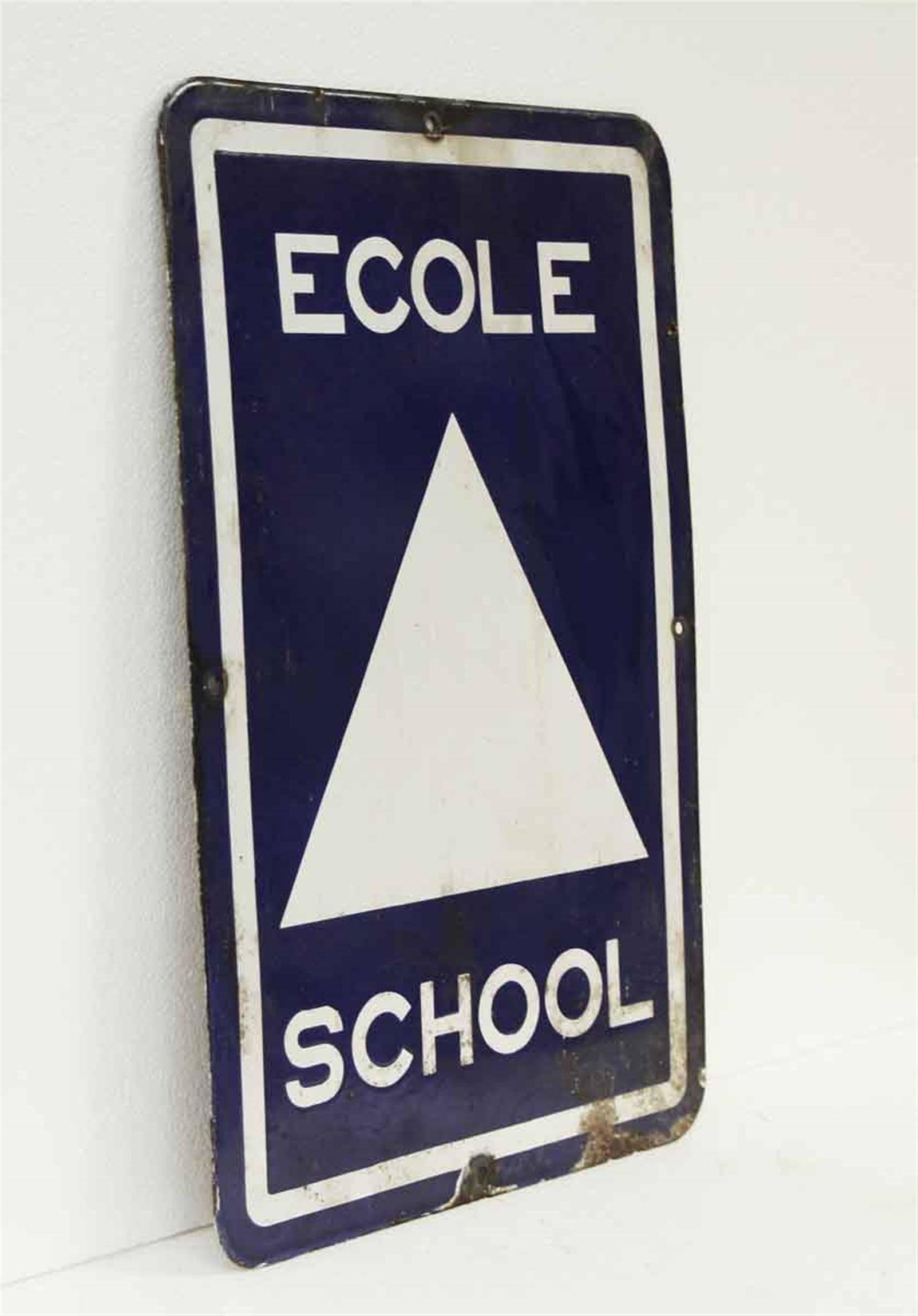 1970s blue and white metal Ecole school sign. This can be seen at our 2420 Broadway location on the upper west side in Manhattan.