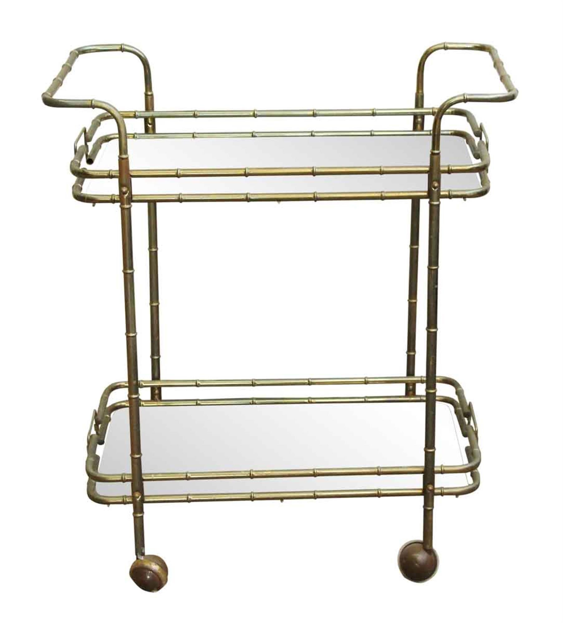 1970s French bar cart with a bamboo like appearance and glass shelves done in a Mid-Century Modern styling. This can be seen at our 5 East 16th St location on Union Square in Manhattan.