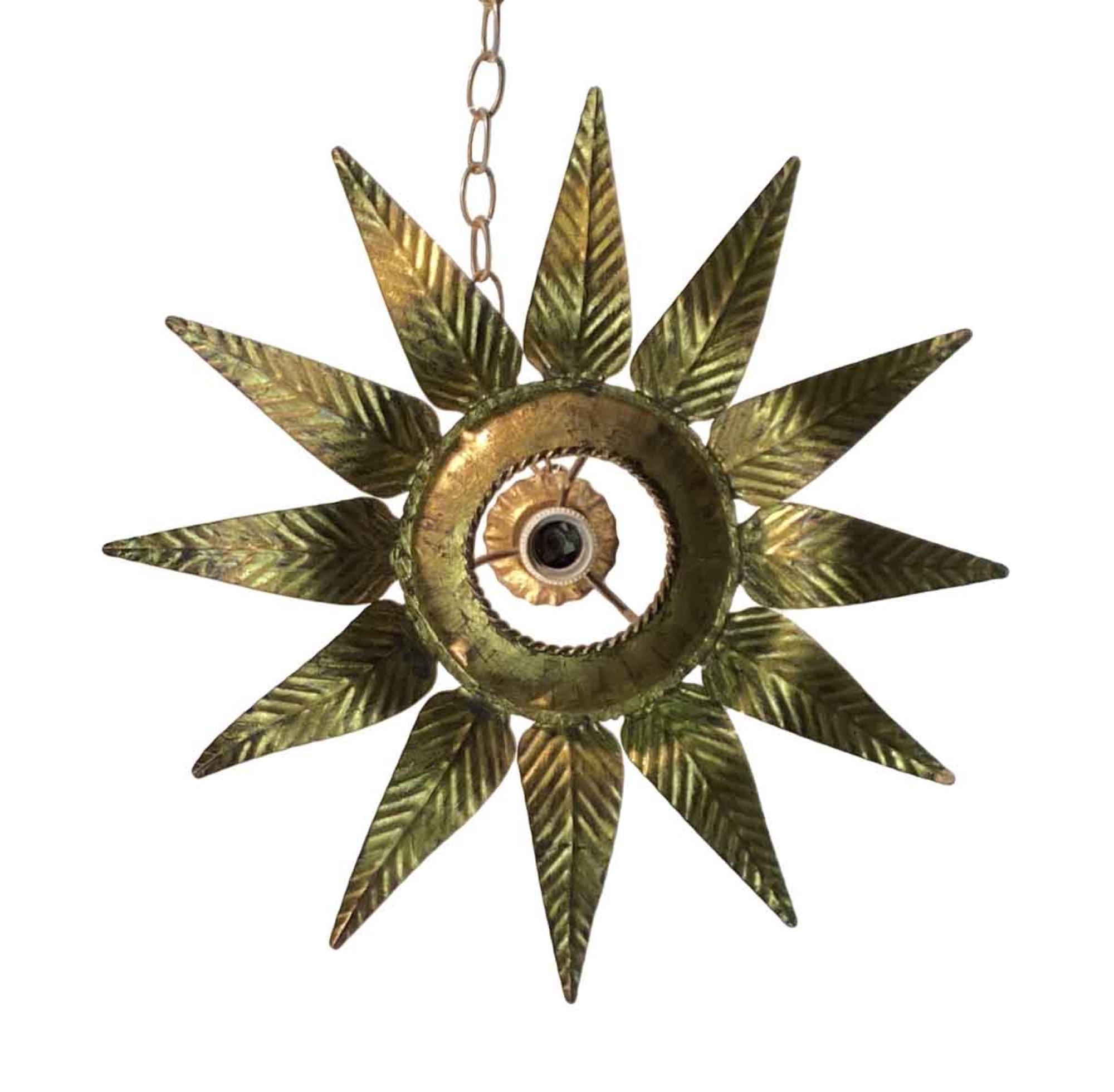 1970s hand hammered gilt leaf star burst pendant light. This can be seen at our 302 Bowery location in NoHo in Manhattan.