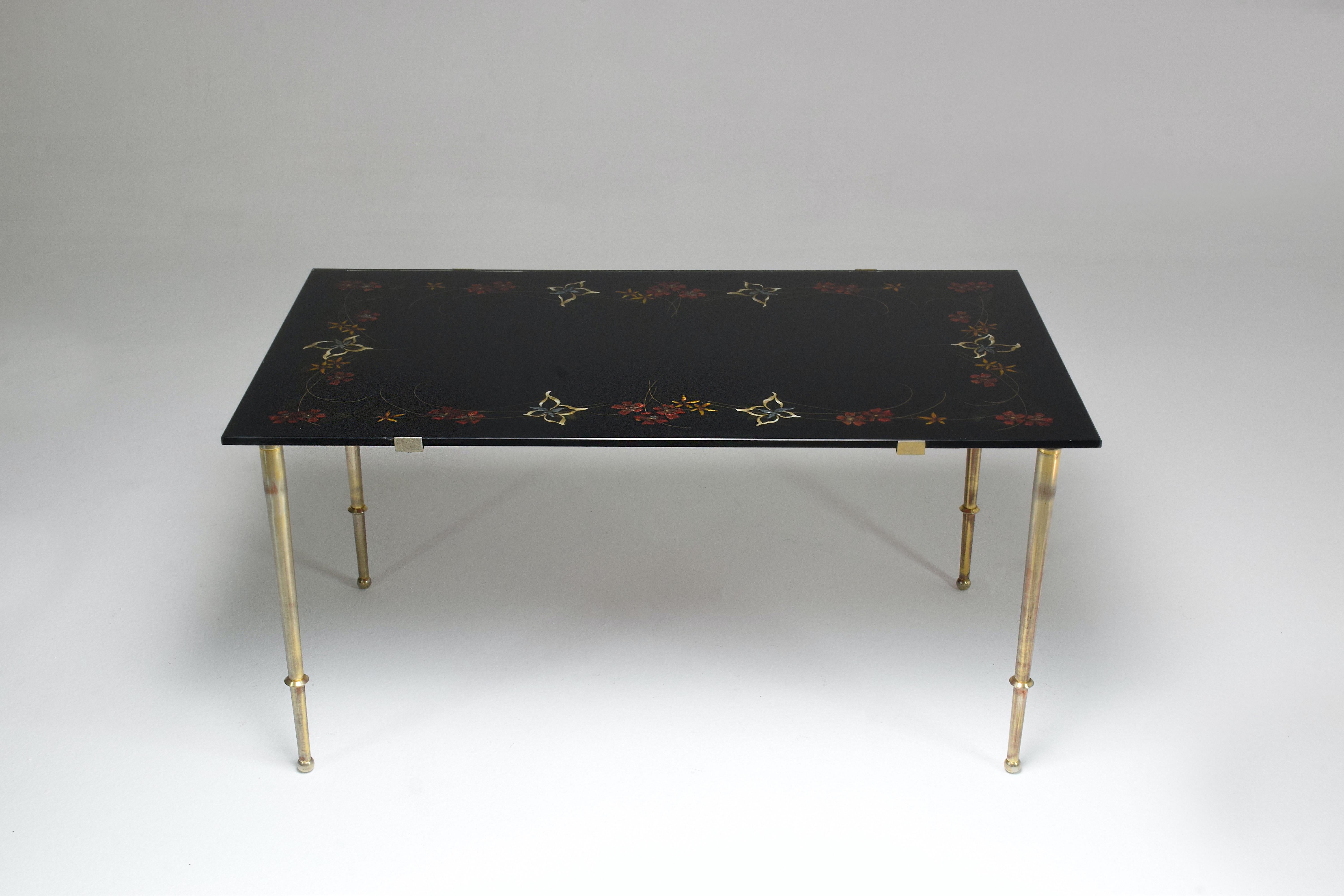A stunning French 20th-century vintage rectangular coffee table composed of slender metal legs and a glass tabletop with beautiful handpainted floral details. 
France. 1970's 

  


We are an exhibition space and an online destination