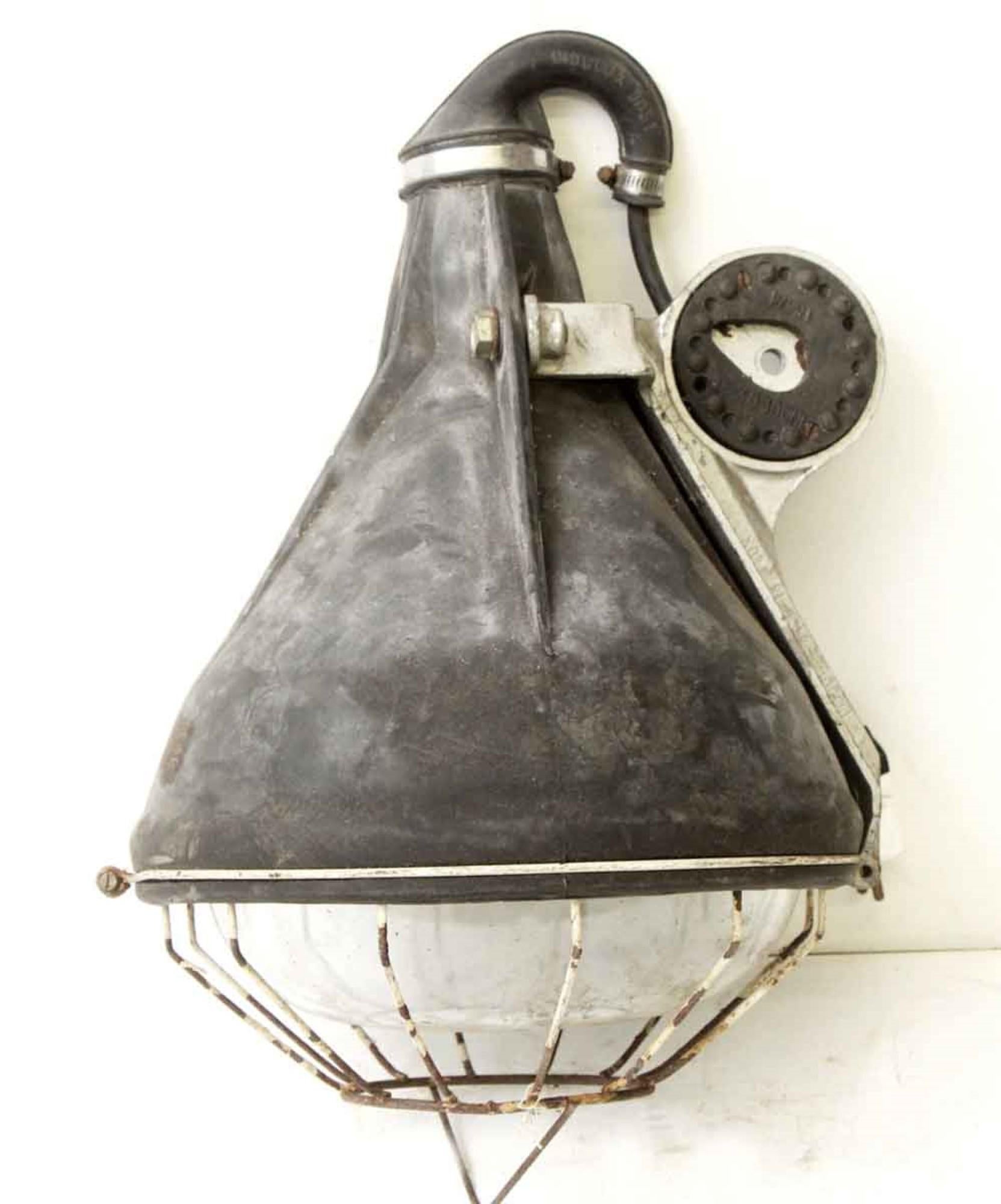 1970s industrial French hanging light with cage. Inscribed INDULUX, lw 9051. This can be seen at our 400 Gilligan St location in Scranton, PA