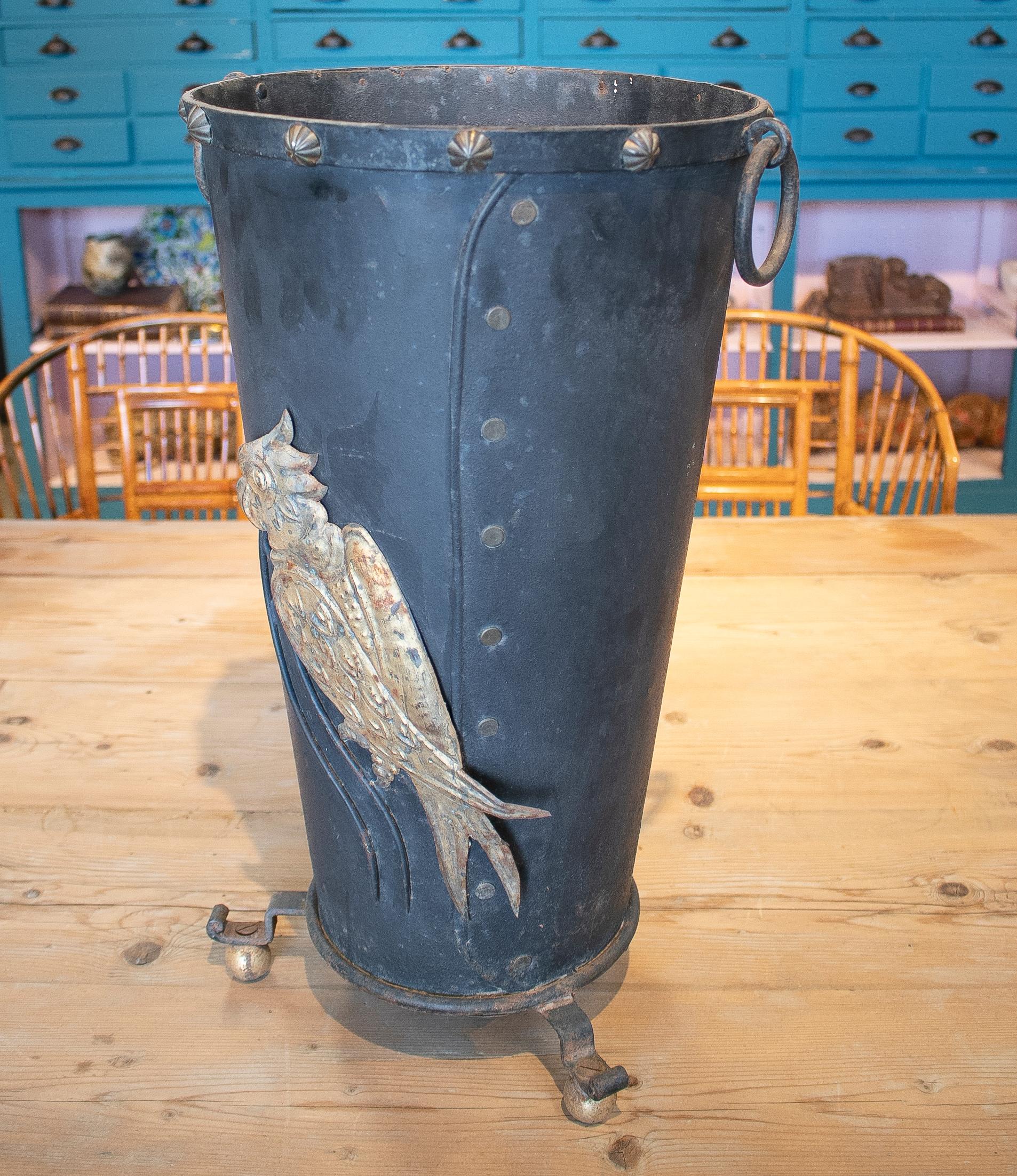 Vintage 1970s French iron umbrella stand with bass-relief parrot decoration.