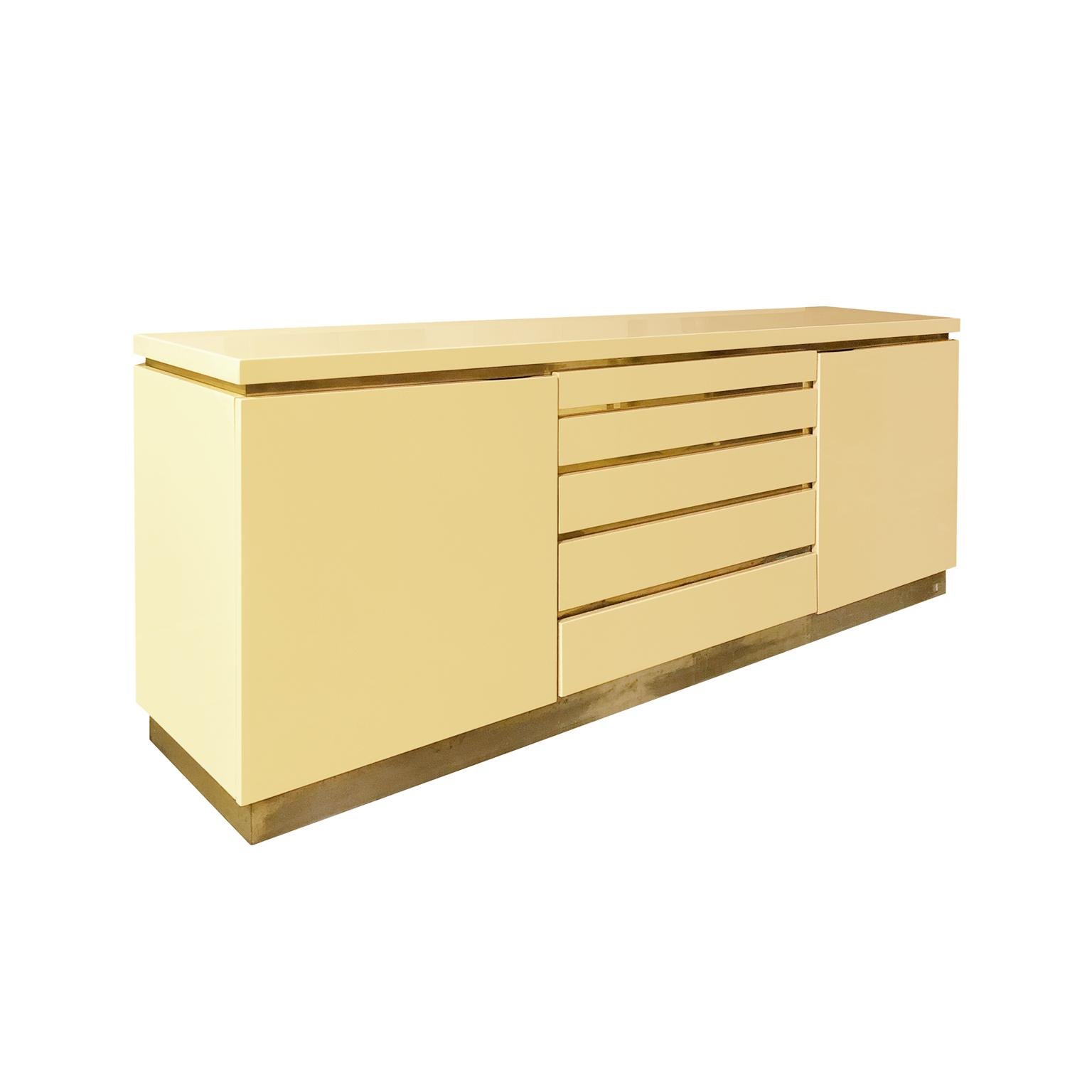 Rectangular ivory lacquer sideboard with brass details by Jean Claude Mahey. Signature on lower right corner, France, 1970s.