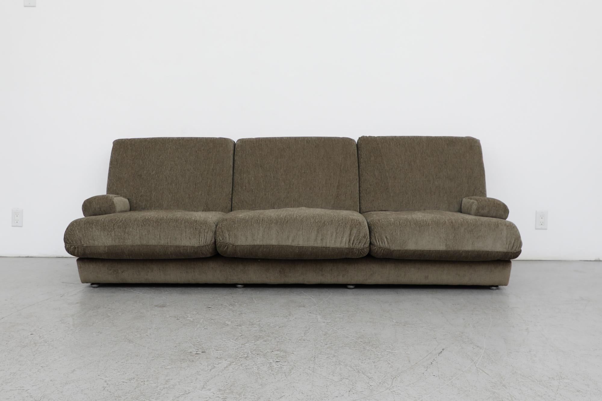 1970's Jacques Charpentier attributed sofa newly upholstered in sage green chenille with stainless steel accented armrests. Similar to Willy Rizzo Sectional Sofa for Mario Sabot. A low and stealth three seater sofa with Francois Monnet style