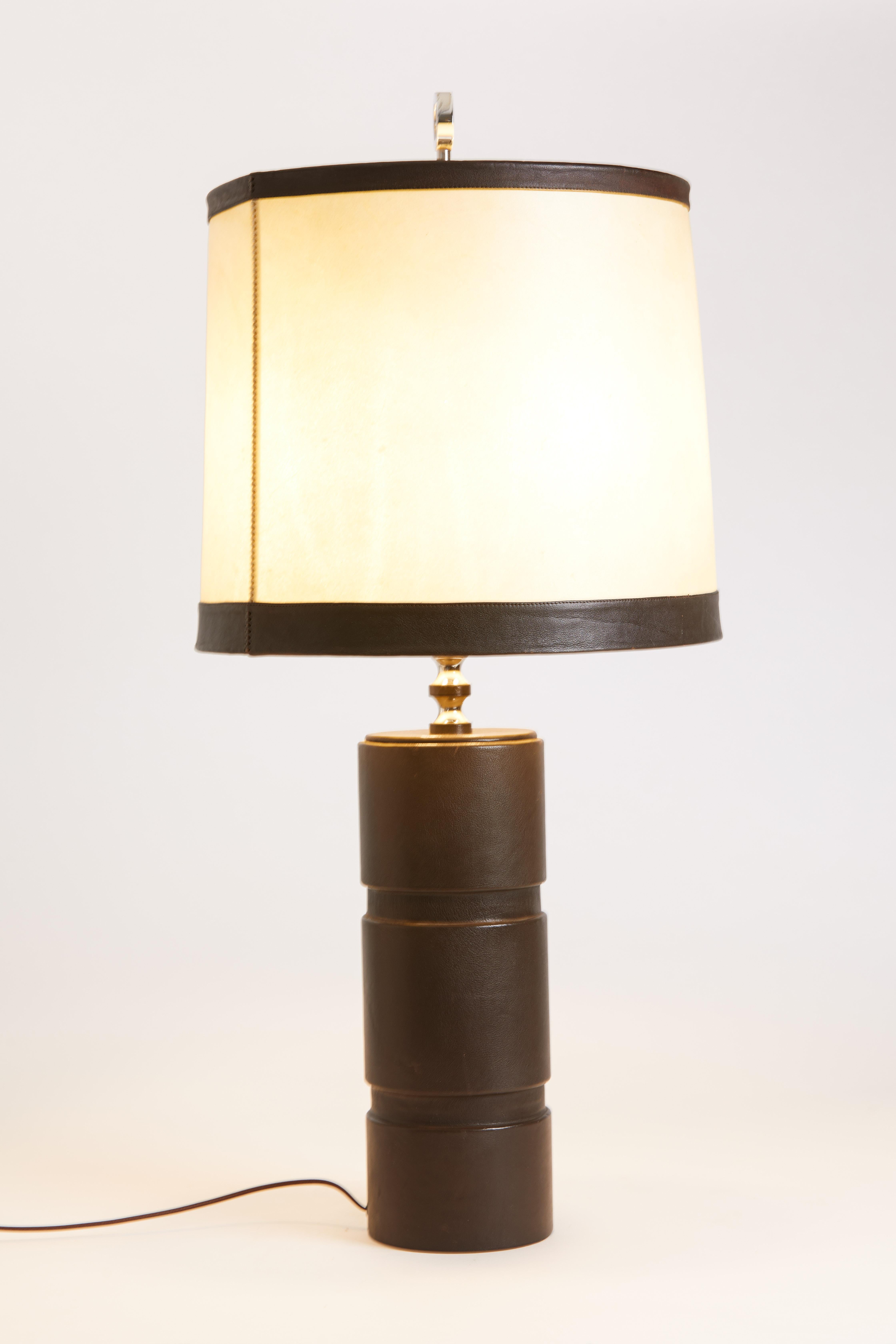 1970s French leather table lamp with chocolate brown trim and parchment shade.