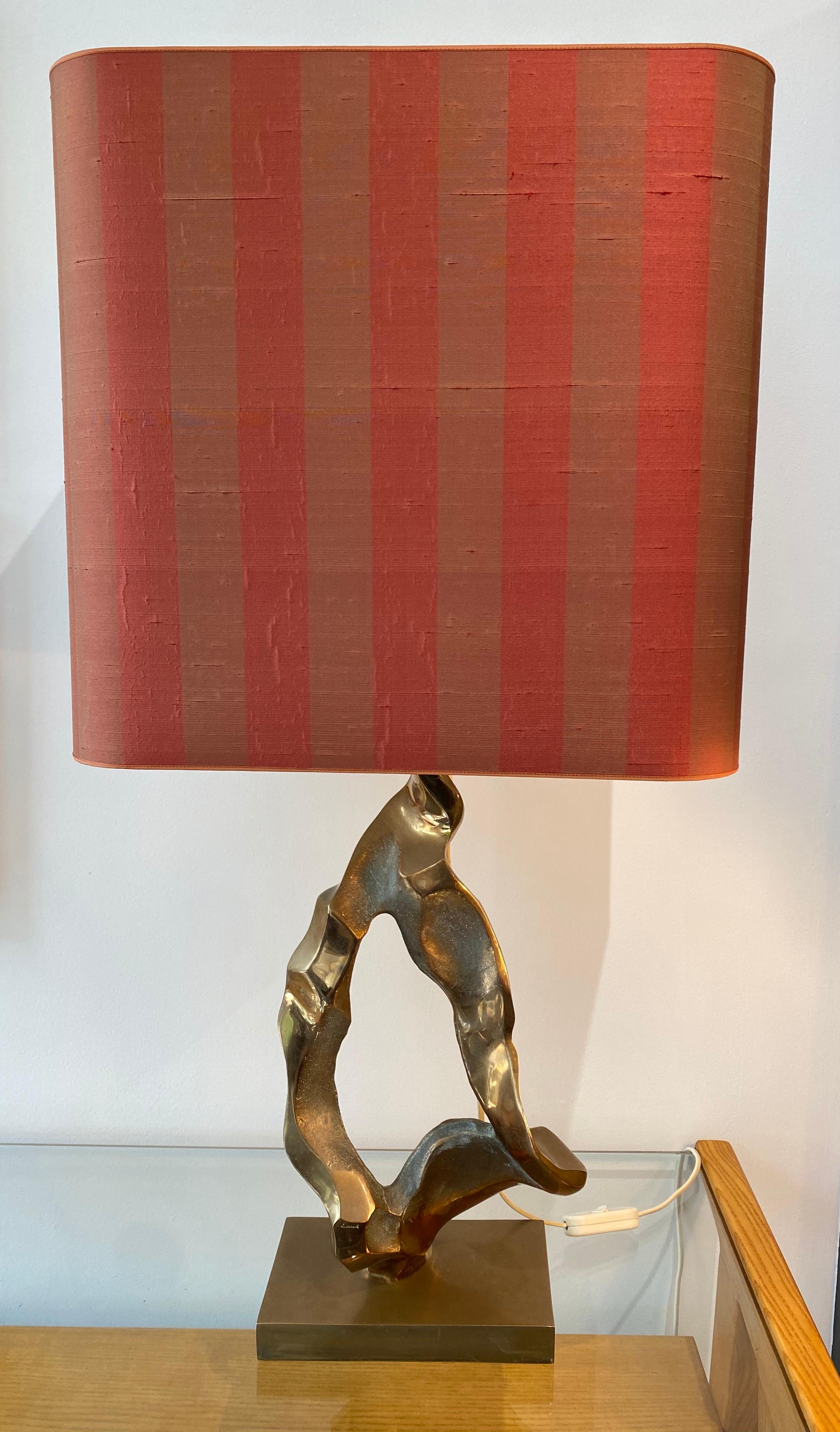 An abstract bronze sculptural table lamp by the French artist and sculptor Michel Jaubert with original shade. 
Signed M.Jaubert

Total height including shade: 82cm.
