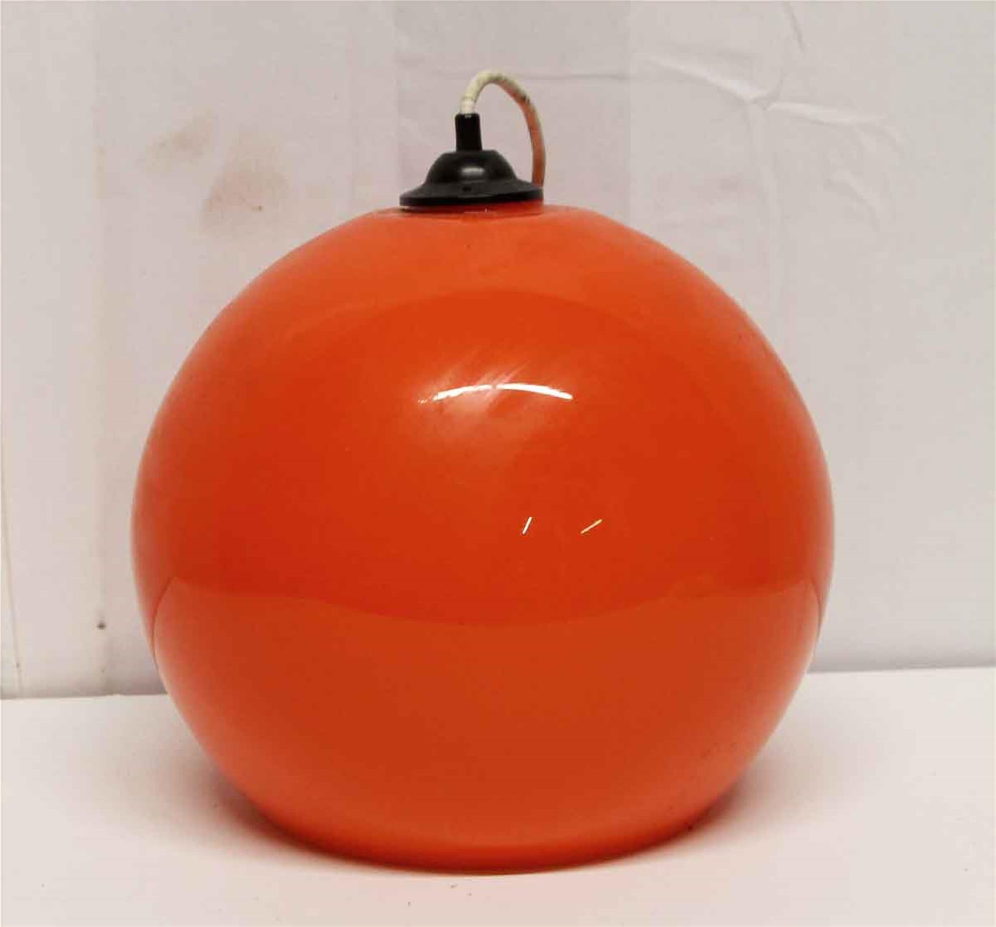 Mid-Century Modern opaline glass orange pendant light fixture from 1970s, France. This can be viewed at one of our New York City locations. Please inquire for the exact address.
