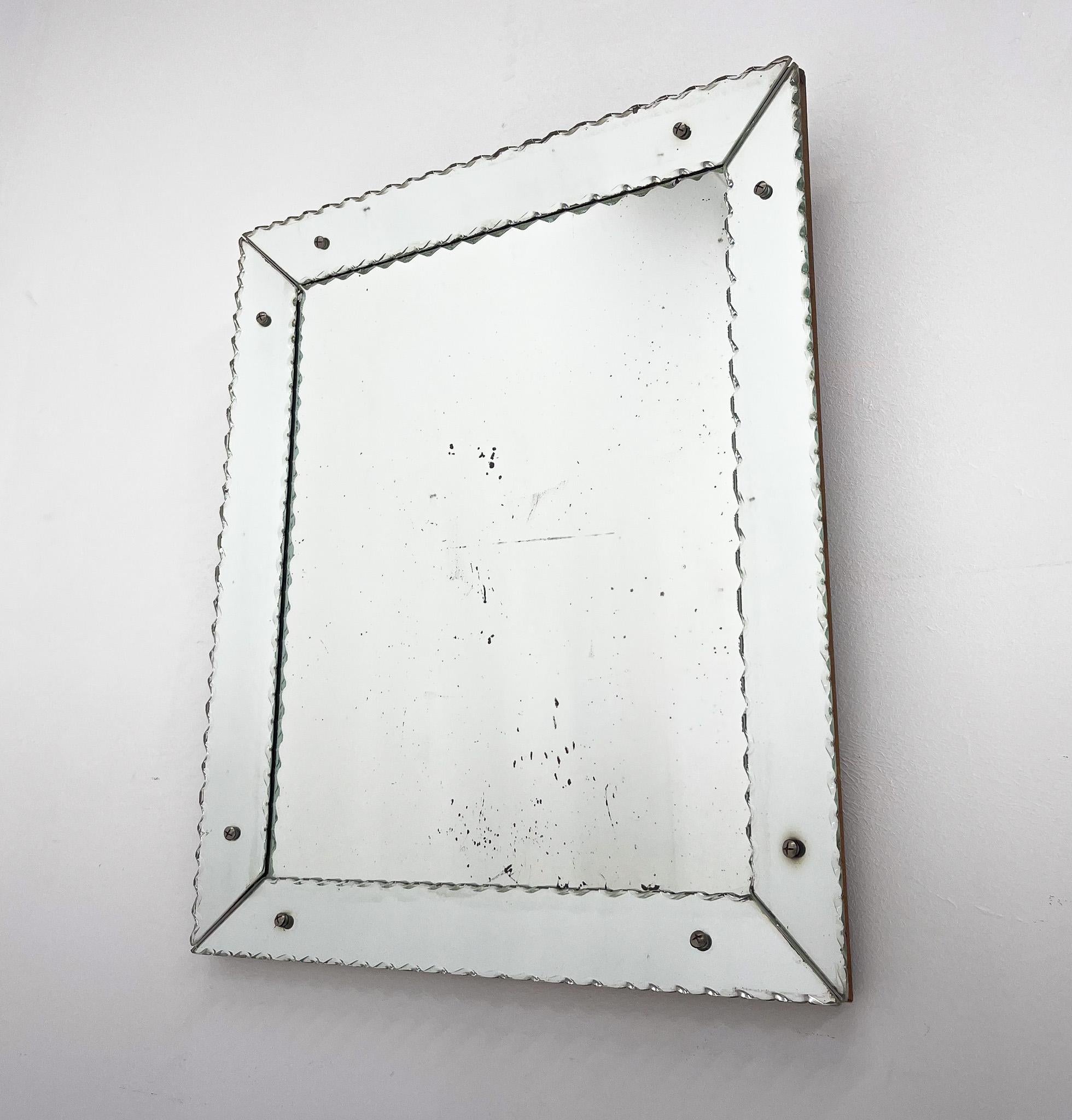 Beautiful mirror with signs of wear and tear over time on wooden frame.