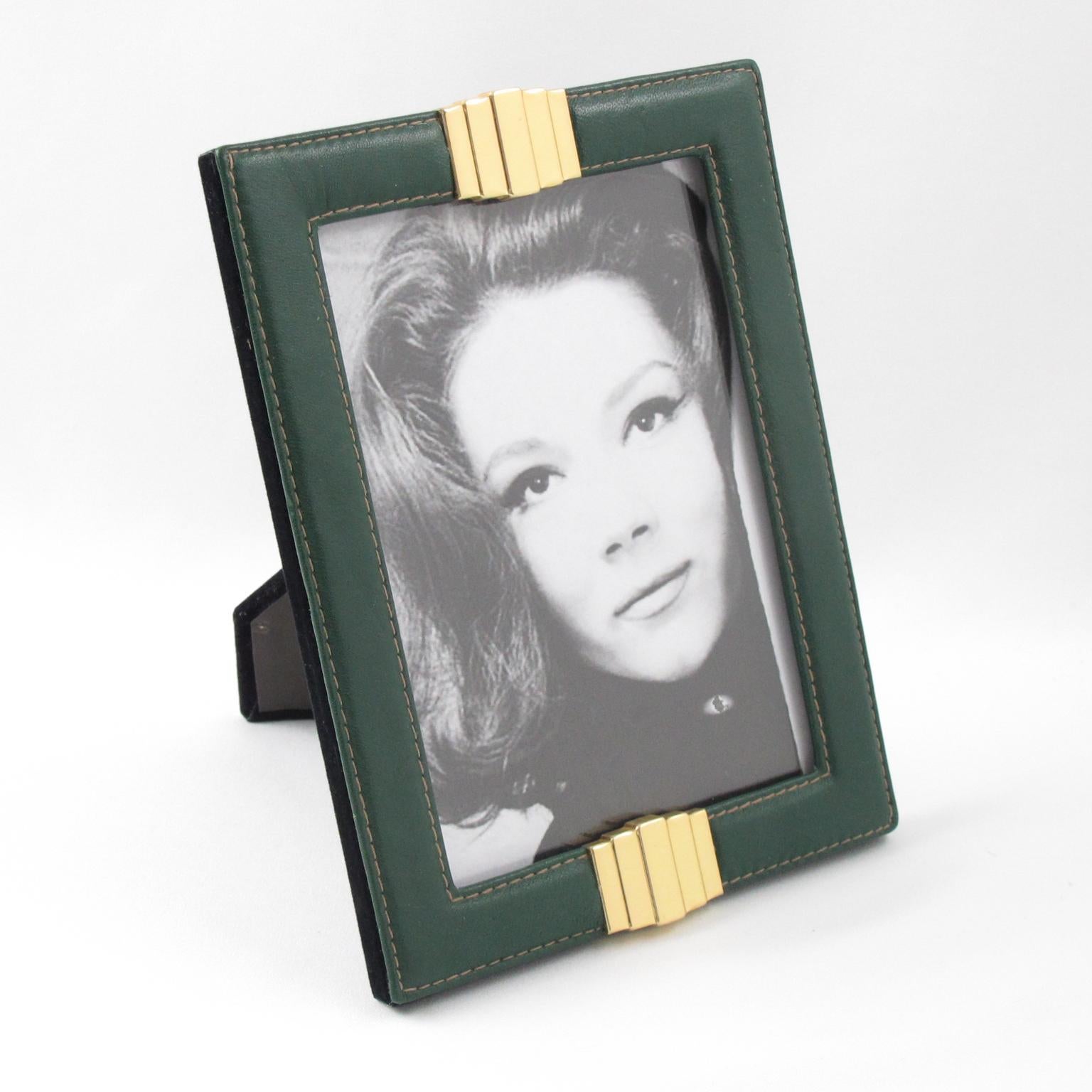 Elegant 1970s French picture photo frame. Forest green leather with pattern and hand-stitched detailing compliment with gilded brass ornament. Easel and back in black velvet and glass protection. The frame can be placed in portrait or in landscape