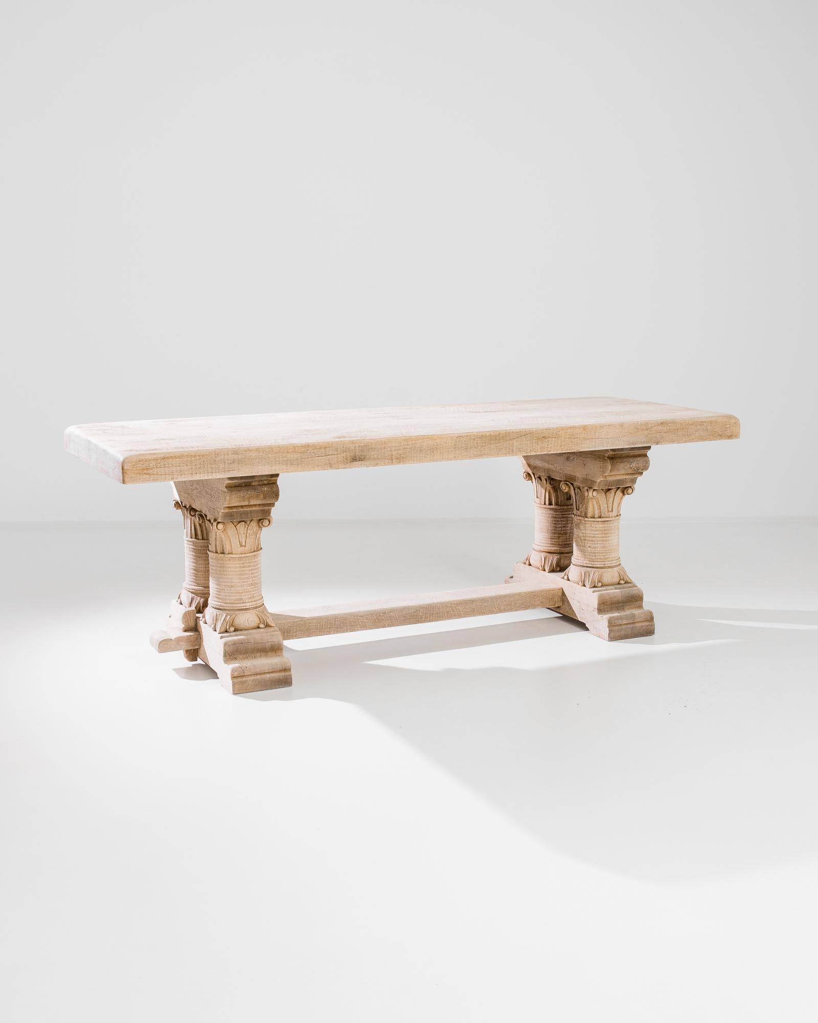 Made in France circa 1970, this rustic dining table features a smooth tabletop elevated on masterfully carved wooden legs connected by a stretcher. Defined by the characteristics of durability and strength, this original table crafted out of solid