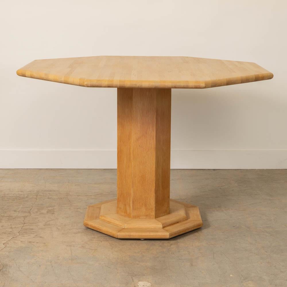 Great oak wood dining table from France, 1970s. Beautiful octagonal wood top with carved pedestal base. Original light wood finish shows nice age, natural grain, and patina. Perfect as a center table or dining table.