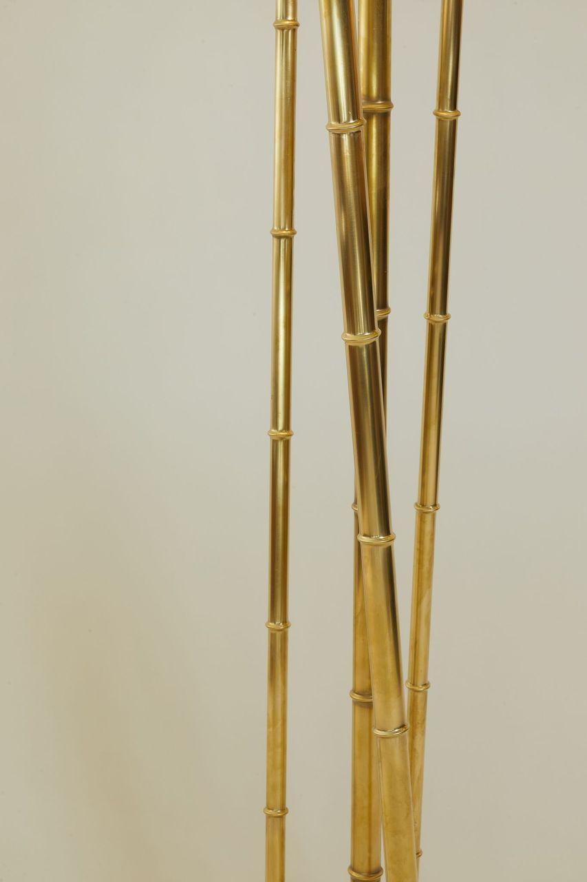 1970s French pair of tall brass floor lamps with bamboo design and travertine base.