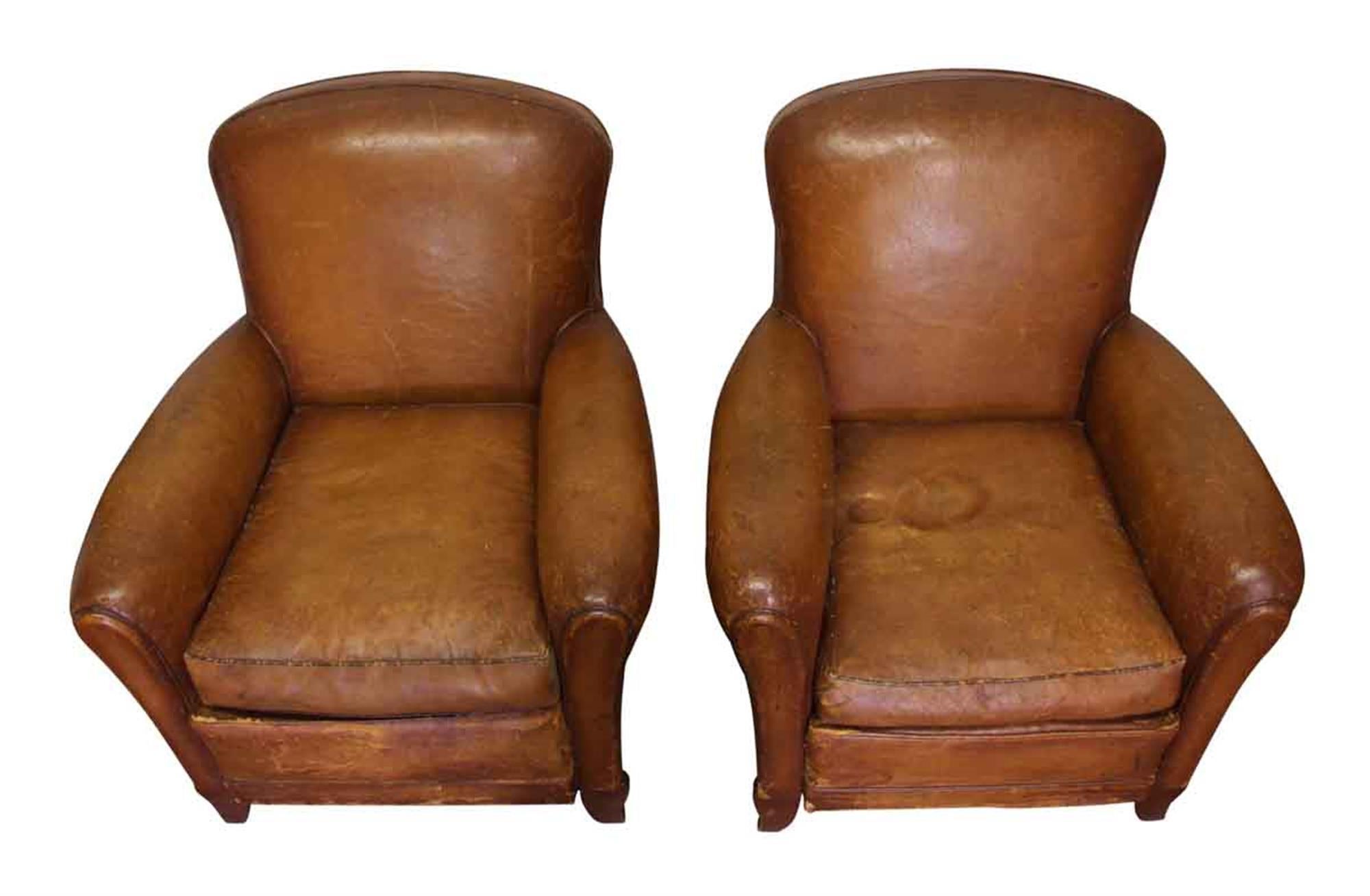 Pair of French leather distressed club chairs with a studded back from the 1970s. This can be seen at our 2420 Broadway location on the upper west side in Manhattan.