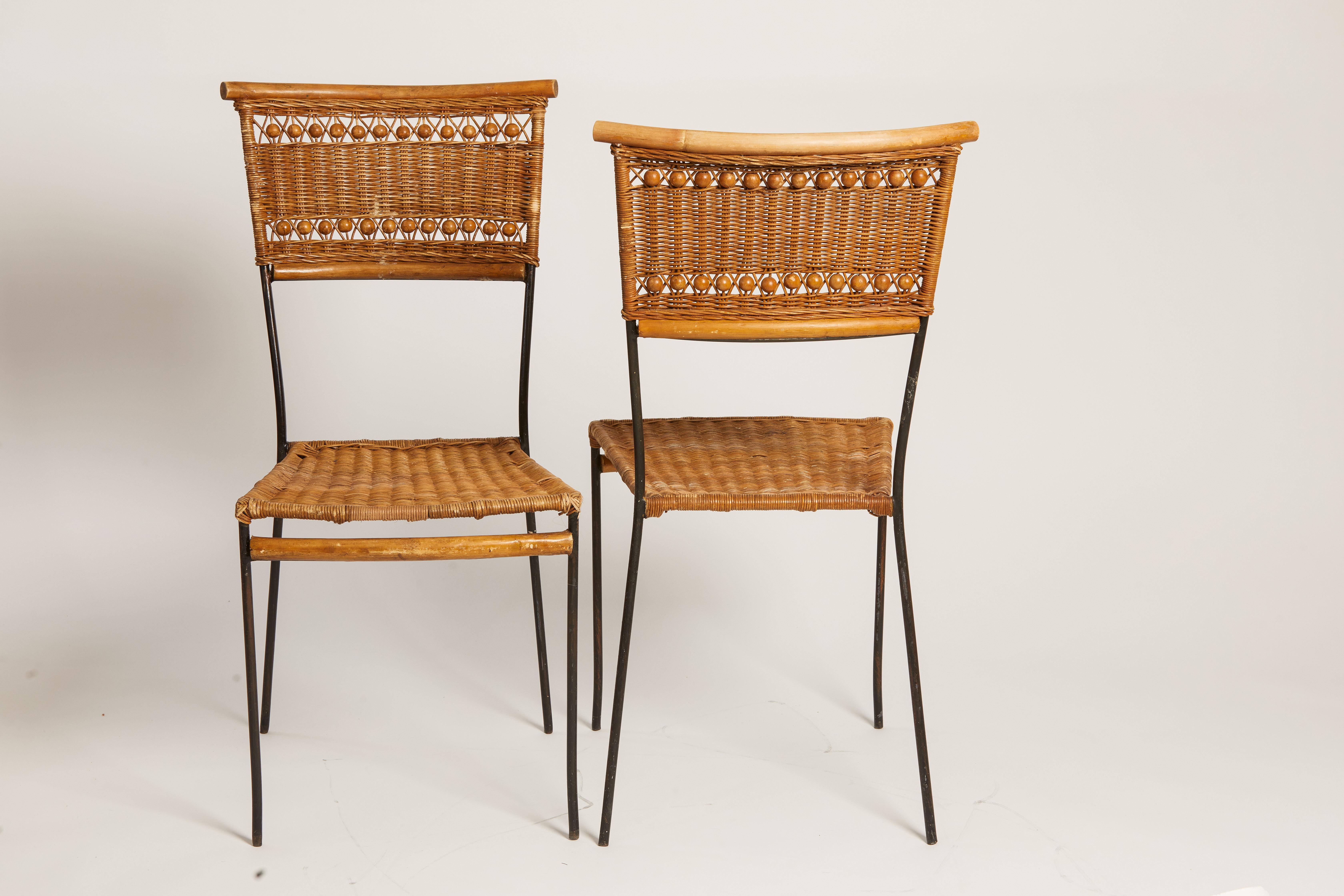 1970s French pair of decorative raffia chairs with wooden beads and black metal detailing.