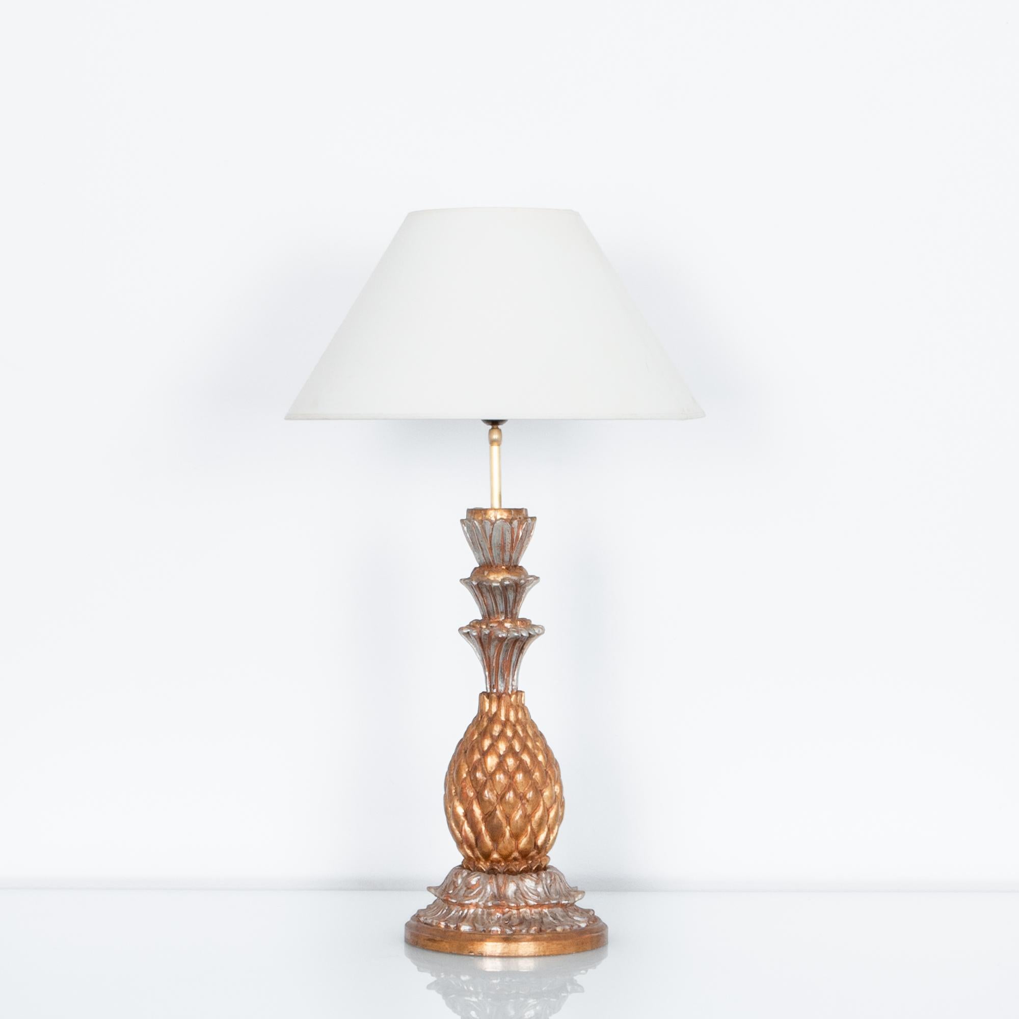 This perishable fruit is a historic symbol of wealth and luxury. This aptly painted 70s French lamp, renders the classic motif in gilded fashion. In a pleasant range of toned gold shades, this wooden lamp has been updated with modern wiring,