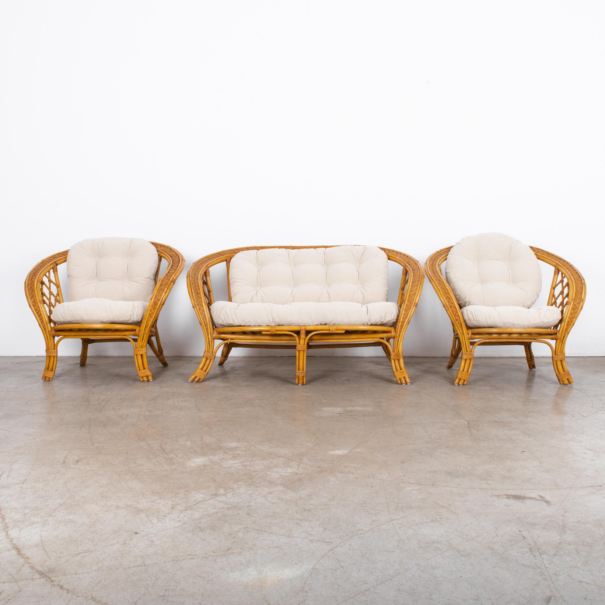 Stunning set of circa 1970s French rattan chairs. With a great curvey form these chairs capture the moment of French midcentury verve. In great shape, topped with fresh updated cushions, a comfy cotton linen blend.