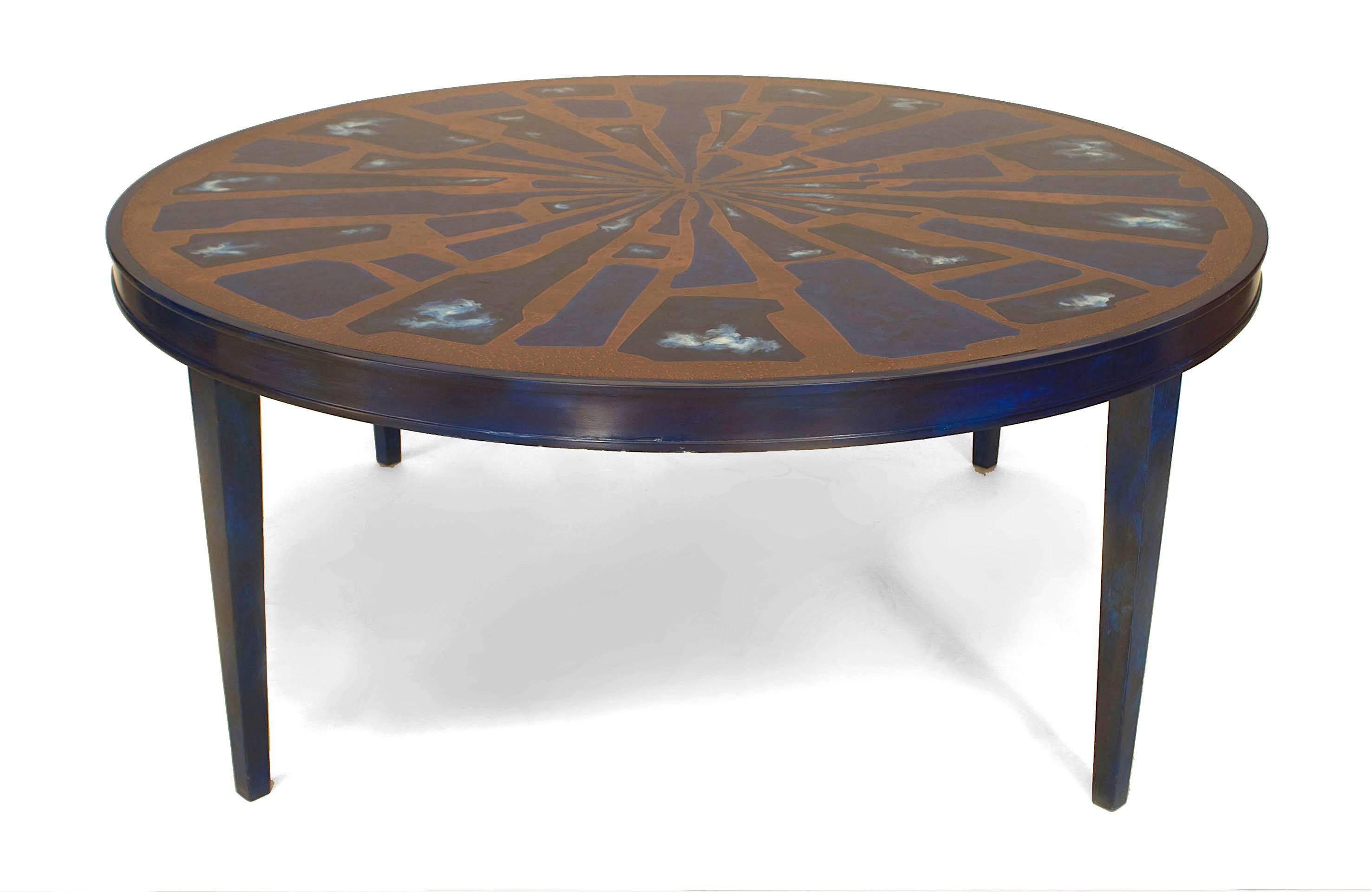 1970's French coffee table supported by four legs beneath a circular top decorated with a blue lacquer and copper free-form sunburst design.
