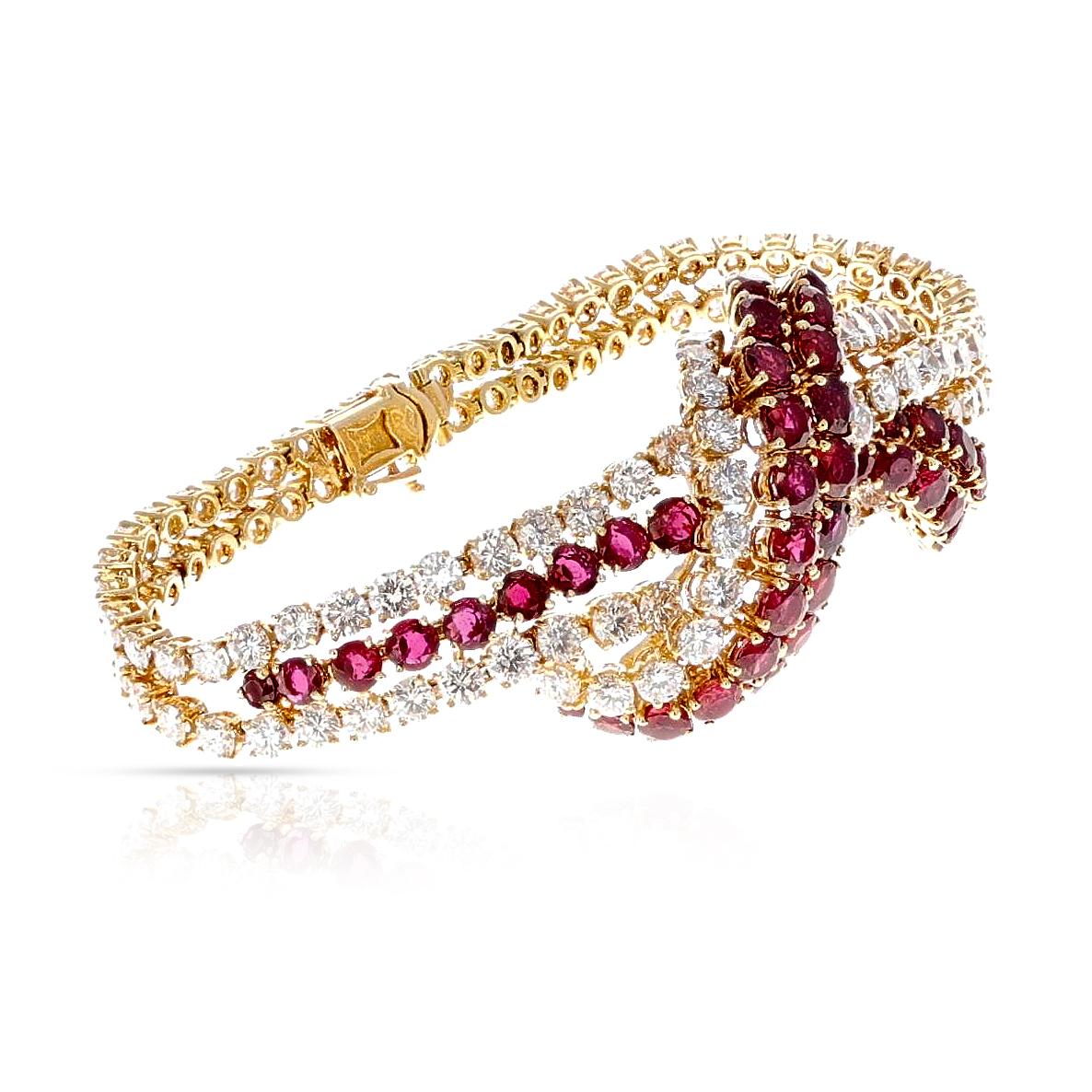 A stunning and rare 1970s French Ruby and Diamond Bracelet by Andre Vassort and M. Gerard, former Van Cleef & Arpels designers. 18K Yellow Gold. Signed and numbered. Total weight of the rubies is appx. 11.50 carats and the total weight of the