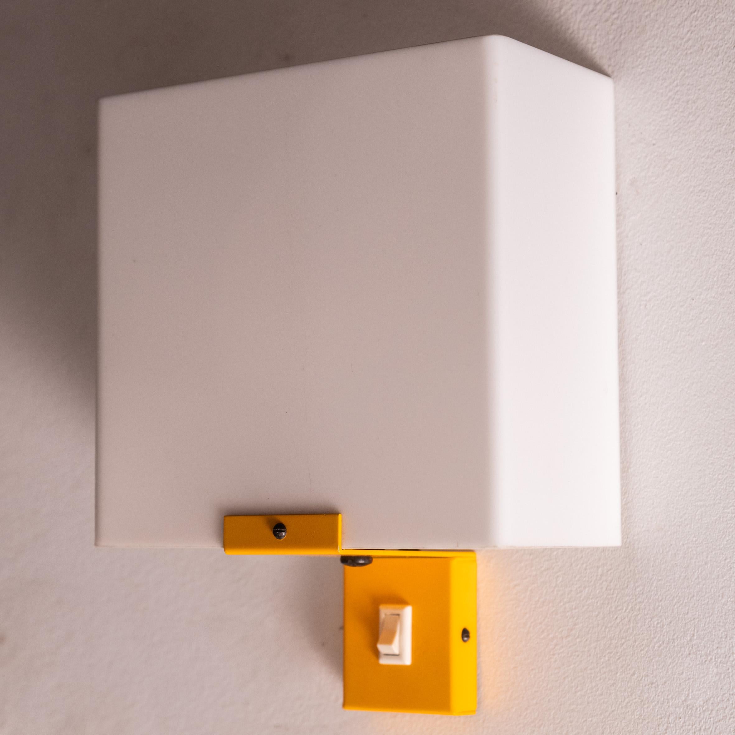 These 1970s French Space Age vintage wall lights are a bold and stylish statement piece, perfect for adding character and charm to any interior. Their eye-catching yellow lacquered metal finish brings a burst of energy and retro flair, while the