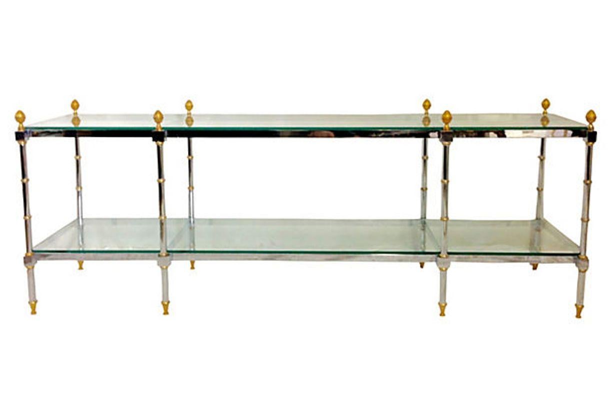 1970s French polished steel chrome-plated and gilt brass two-tier glass top table attributed to Maison Jansen. This Maison Jansen style finely crafted 71' inch long and rectangular multi purpose table can be used as a sofa, hall, console or display