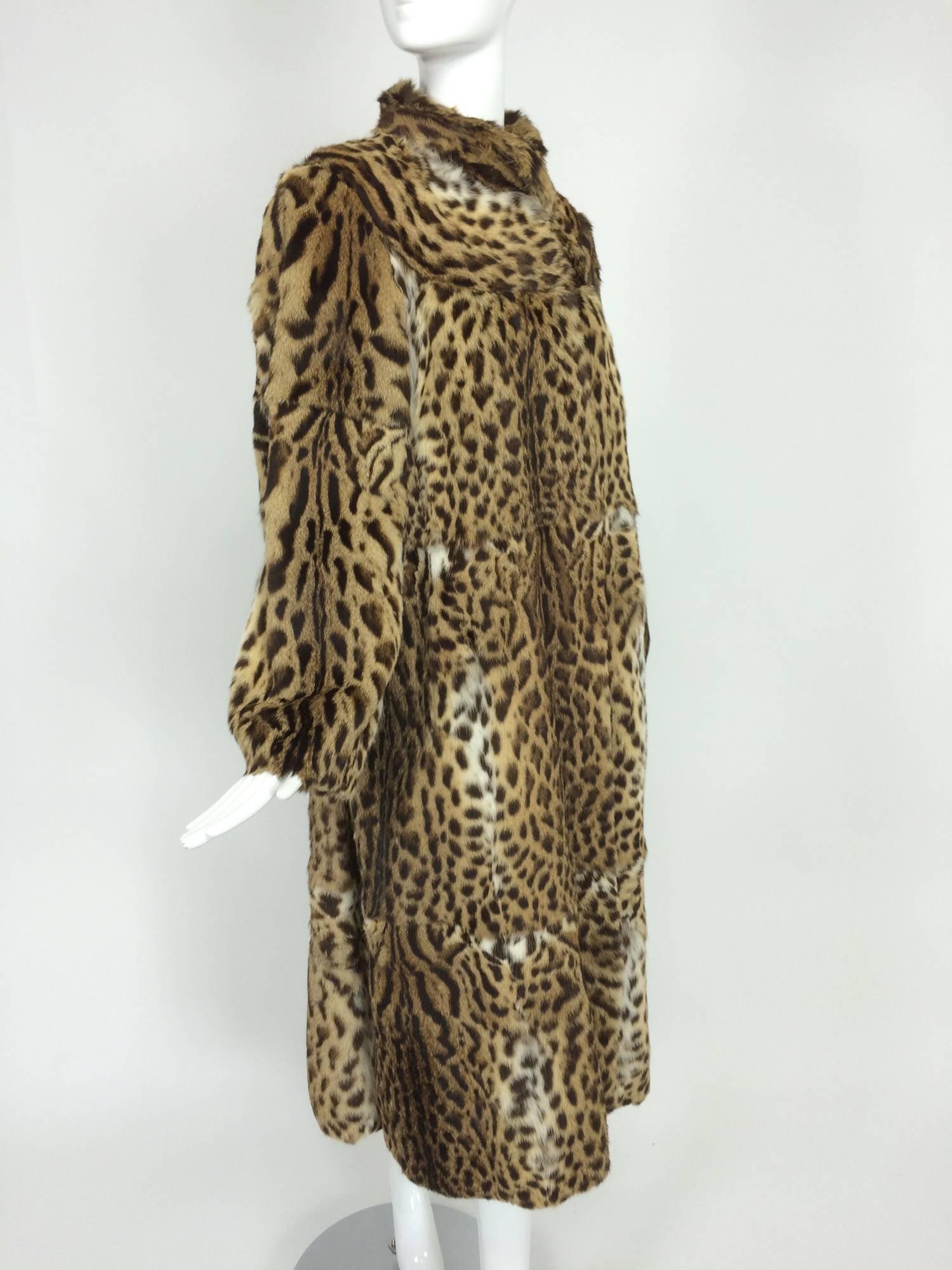 Full length spotted fur coat labeled Yorn Boutique, Germany. Beautiful soft fur coat with yoke shoulder, stand up collar and long semi full sleeves that taper at the wrist. The coat closes at the front with fur hooks, it is fully lined and in