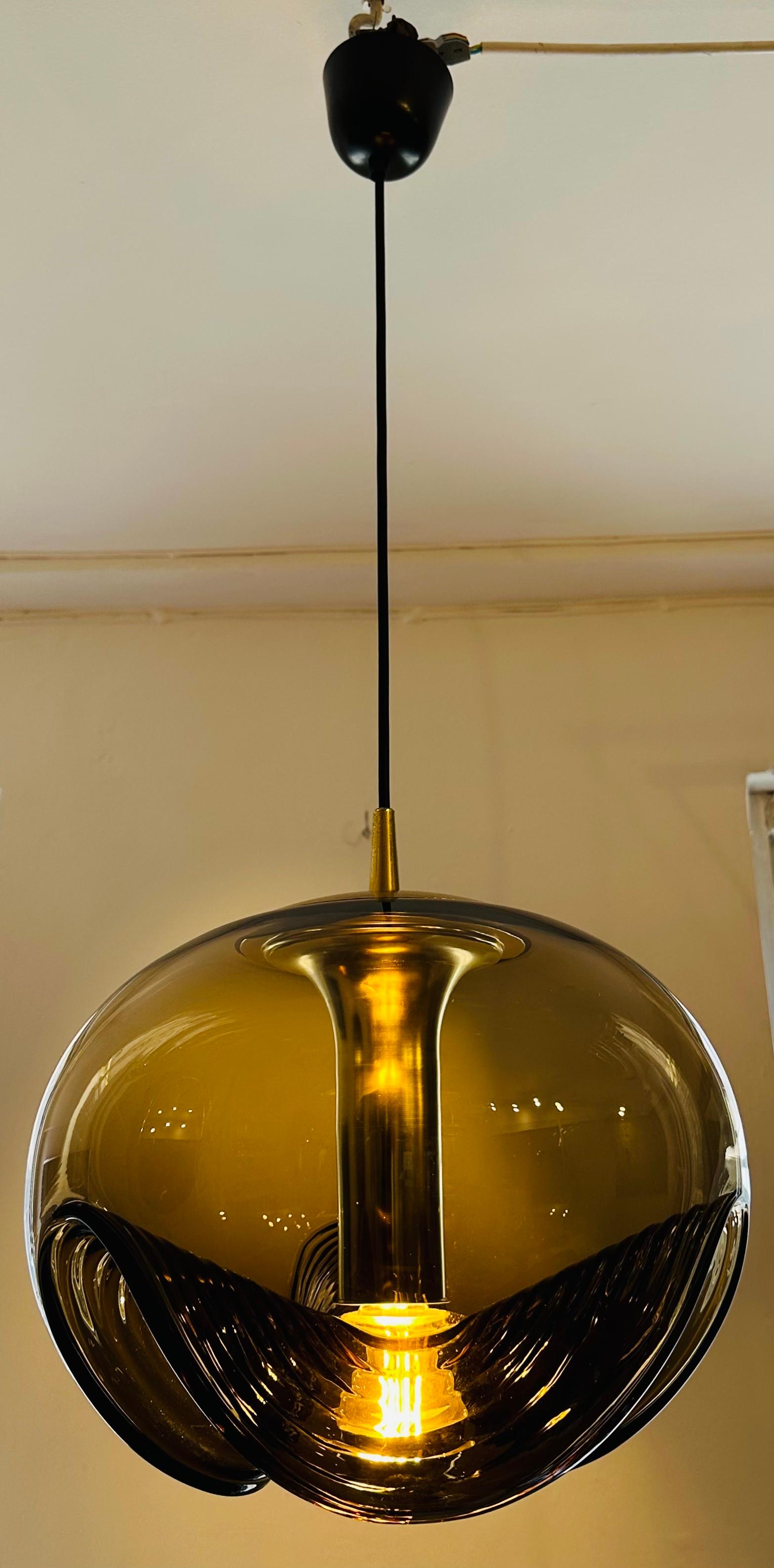 The largest version of this beautiful hanging pendant light from the 'Futura' range which is also more commonly called 'Wave' which was manufactured in Germany by Peill & Putzler during the 1970s. The three-wave smoked ribbed glass shade is