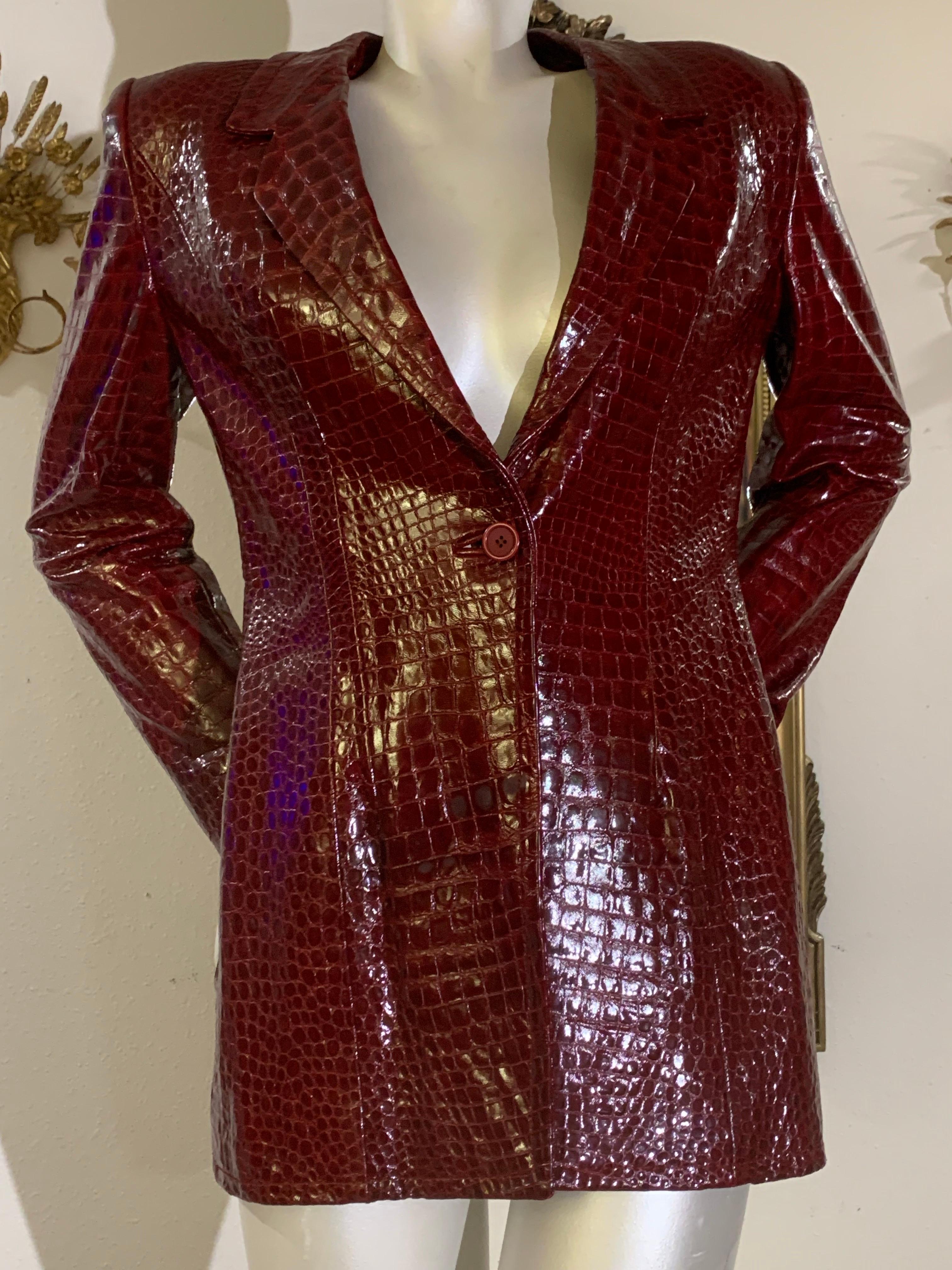 1970s James Galanos Burgundy Crocodile Embossed Genuine Patent Leather Jacket w Side Pockets: Wonderful tailored with sharp notched lapels and structured shoulders. Single center button at front. Fingertip length. Lined in burgundy silk charmeuse.