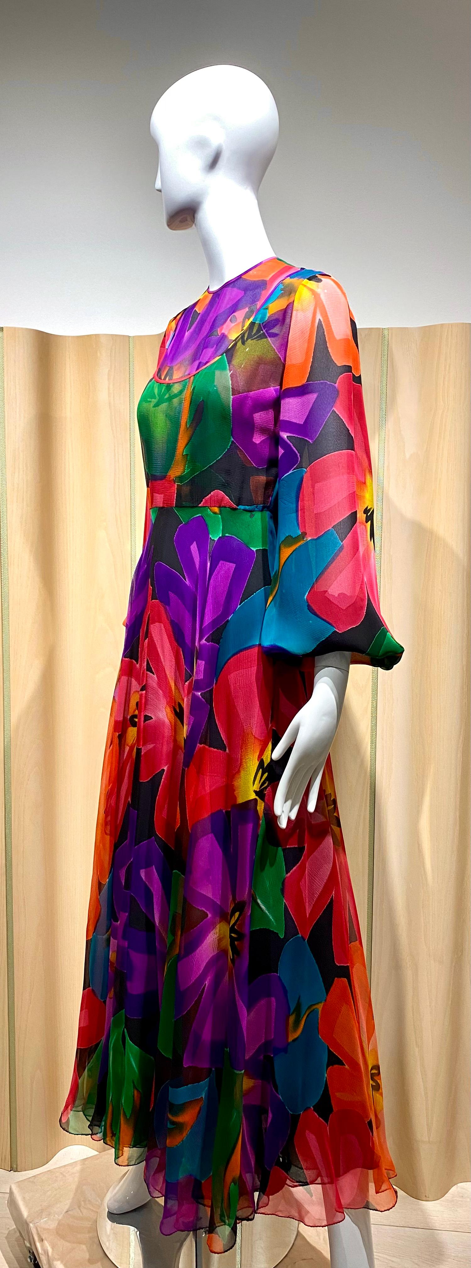 1970s Galanos for Amelia Gray Purple, Blue, Green , orange and yellow Abstract print flown silk chiffon gown with billowy sleeves.
Size: Small / 4
Measurement; 
Bust: 34’  / Waist: 26”  / Hip:   / Shoulder:   / Dress Length:  52”

Note: There is a