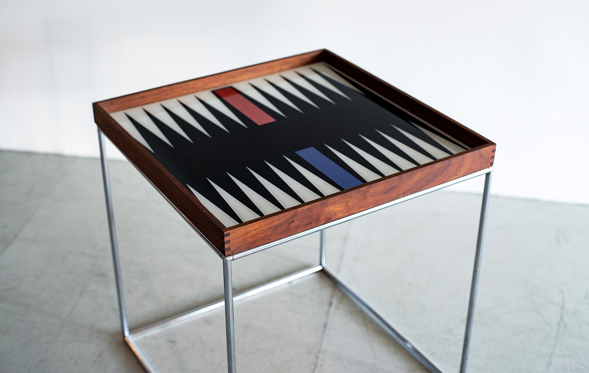 1970s modern custom backgammon table by Austin cox enterprises.
Teak table frame with custom glass game board on metal cube frame.
Dovetail corners show craftsmanship.
Great piece!
 